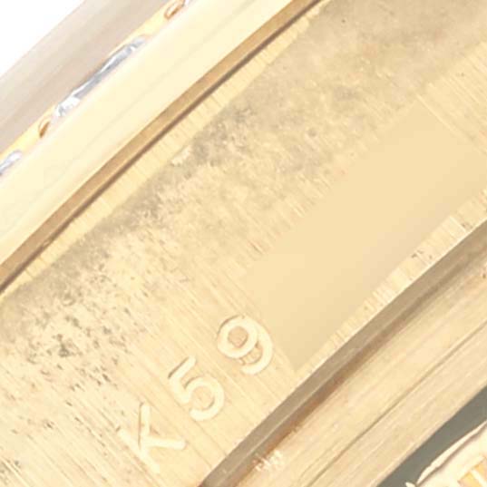 The image shows a close-up angle of the Rolex Pearlmaster 80298 Women's Yellow Gold Champagne Dial 80298 Women's Yellow Gold Champagne Dial band with gold links and engraved details.