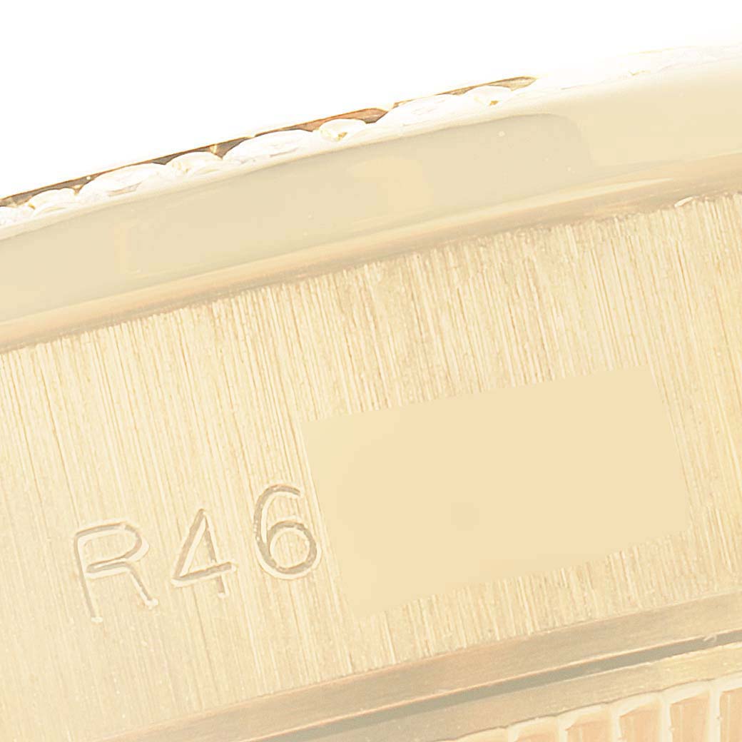 This is a close-up angle showing the side engraving on the case of the Rolex President 69138 Women's Yellow Gold Black Dial 69138 Women's Yellow Gold Black Dial model watch.