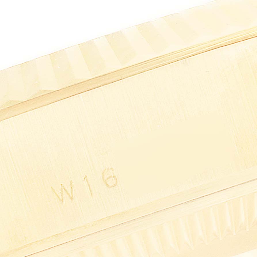 This image shows a close-up of the side view of the President model by Rolex, highlighting the engraved serial number and part of the fluted bezel.