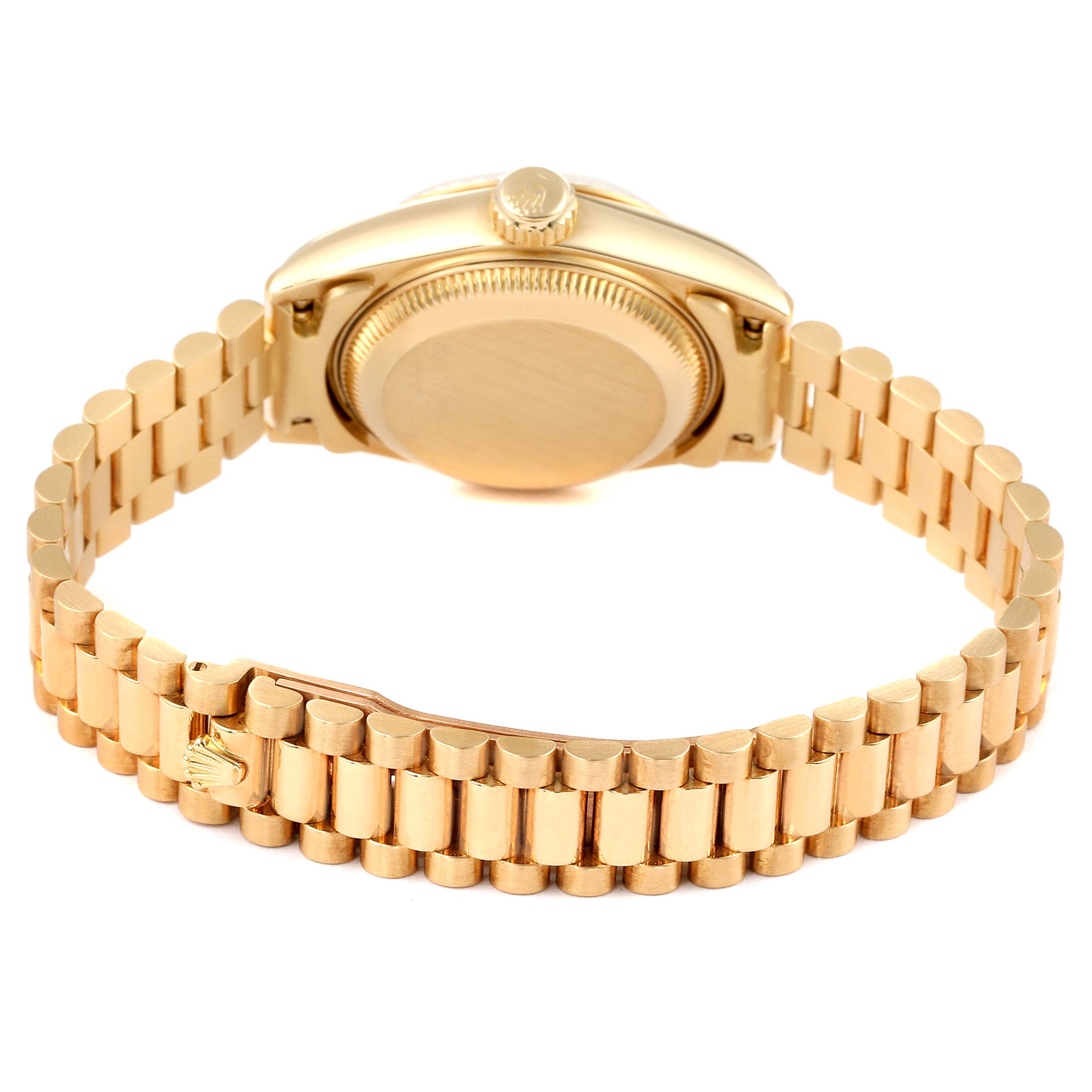 The image shows the back of a Rolex President 69178 Women
s Yellow Gold Champagne Dial 69178 Women
s Yellow Gold Champagne Dial watch, highlighting its gold case and president bracelet.