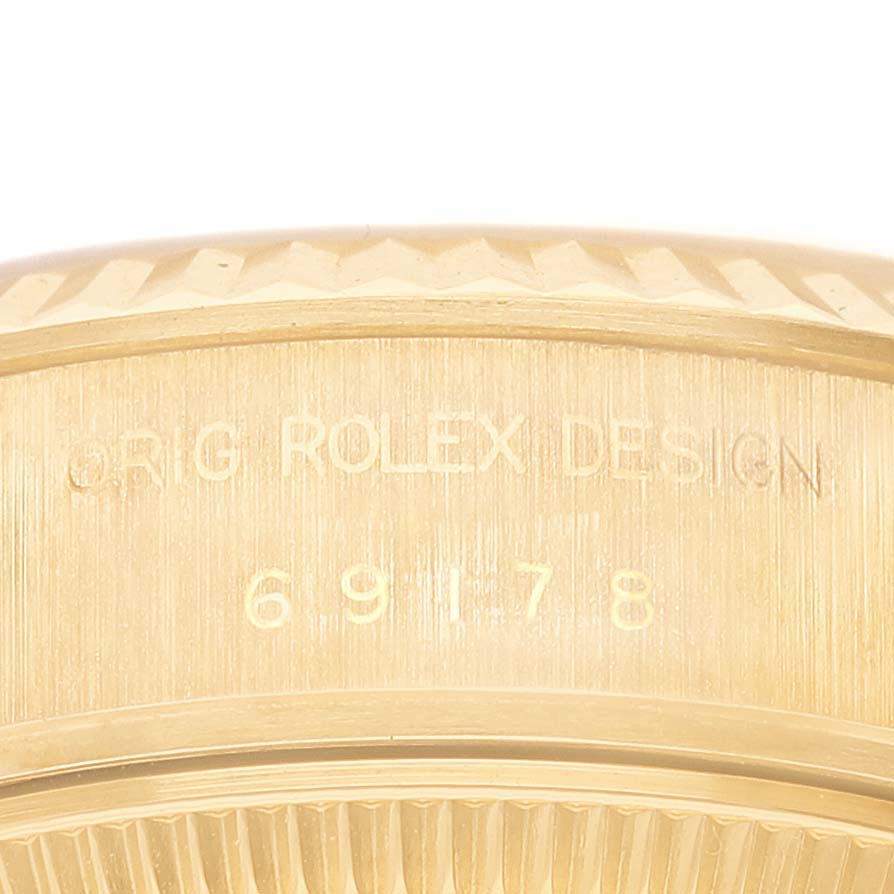 This close-up image shows the engraved serial number and design markings on the bezel of a Rolex President 69178 Women's Yellow Gold Champagne Dial 69178 Women's Yellow Gold Champagne Dial watch.