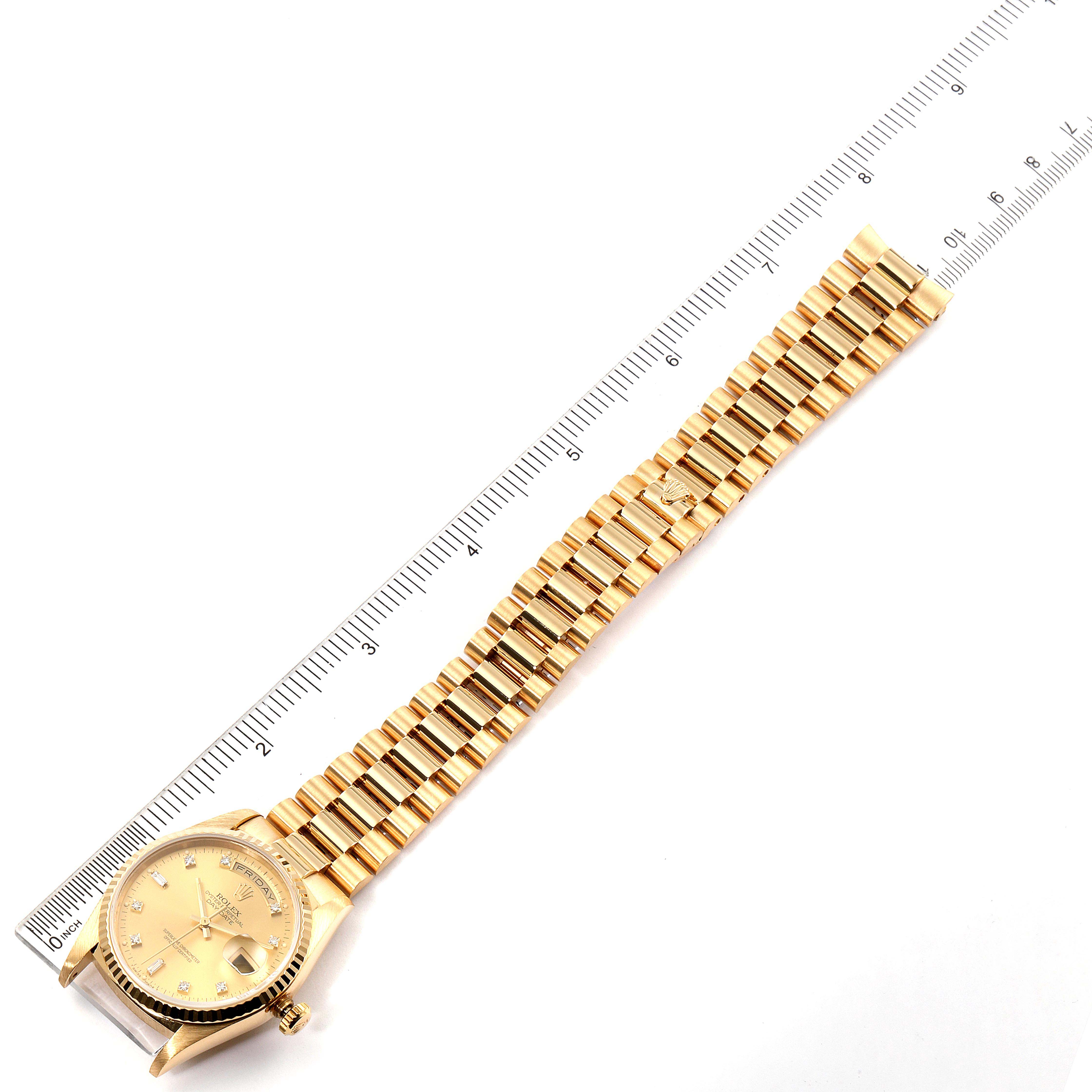 The image shows a top-down view of a Rolex President 18238 Men's Yellow Gold Champagne Dial 18238 Men's Yellow Gold Champagne Dial model watch with a ruler alongside its bracelet.