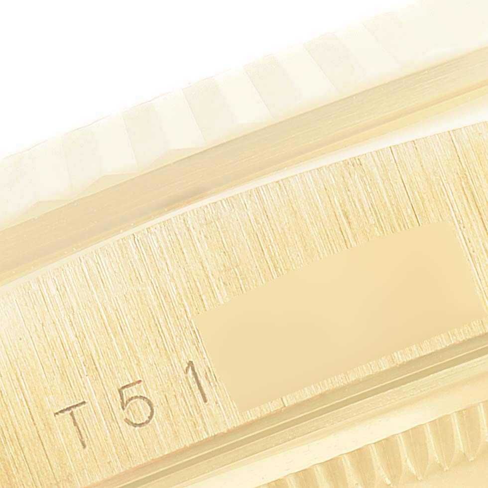 This image shows a close-up of the Rolex President 18238 Men's Yellow Gold Champagne Dial 18238 Men's Yellow Gold Champagne Dial model watch's case side with part of the serial number.