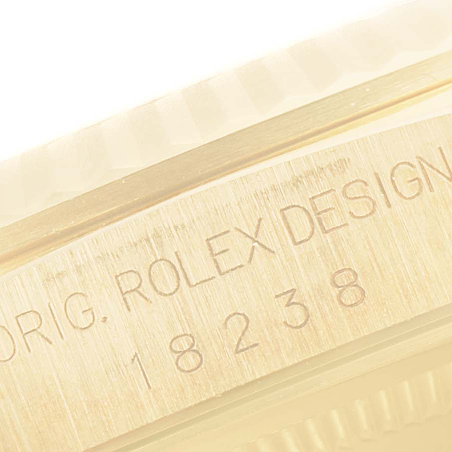 The image shows a close-up of the bezel and engraved case side of a President model Rolex watch.