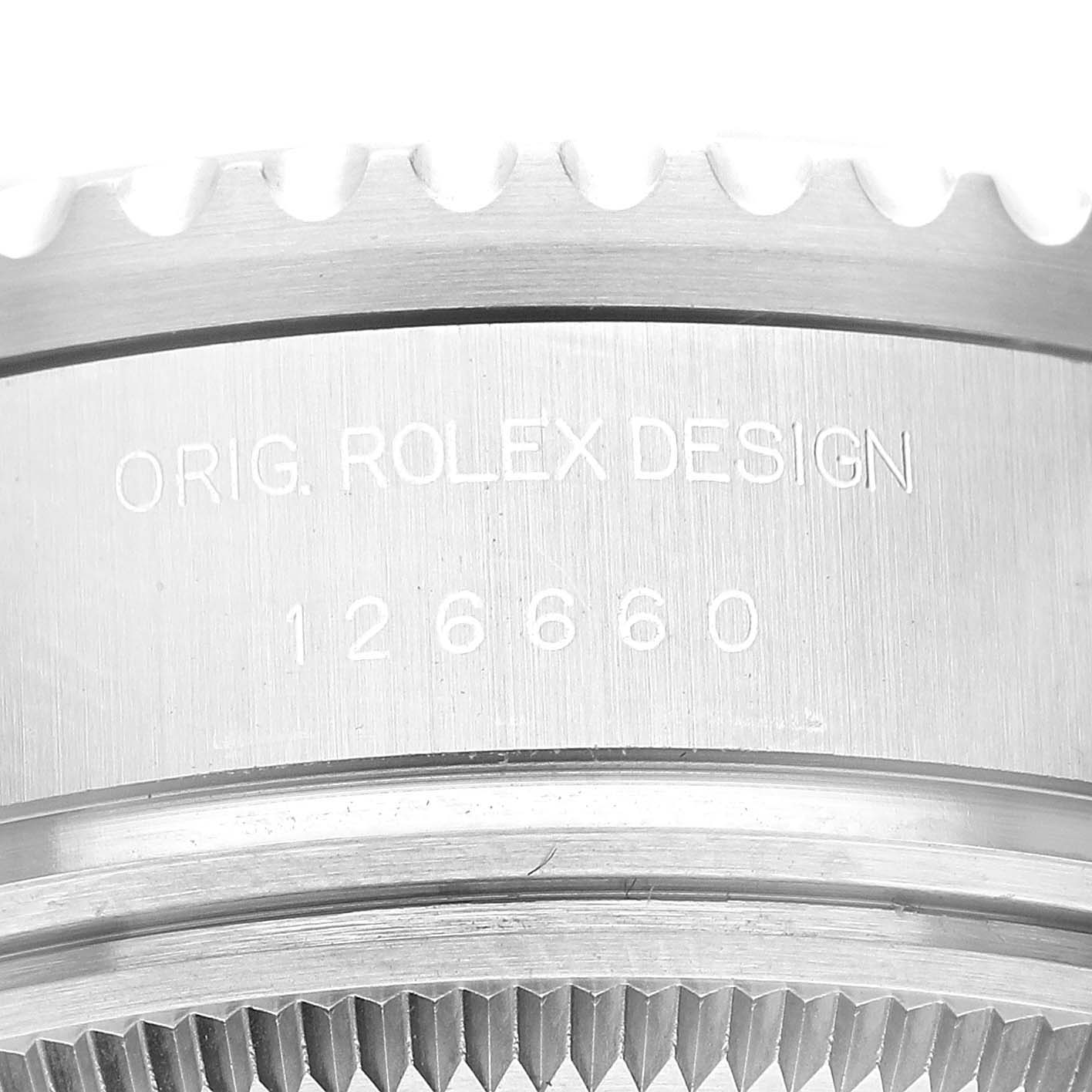 This image shows a close-up of the side profile of a Rolex Sea-Dweller 126660 Men's Stainless Steel Blue Dial 126660 Men's Stainless Steel Blue Dial watch, focusing on the engravings and the toothed bezel.