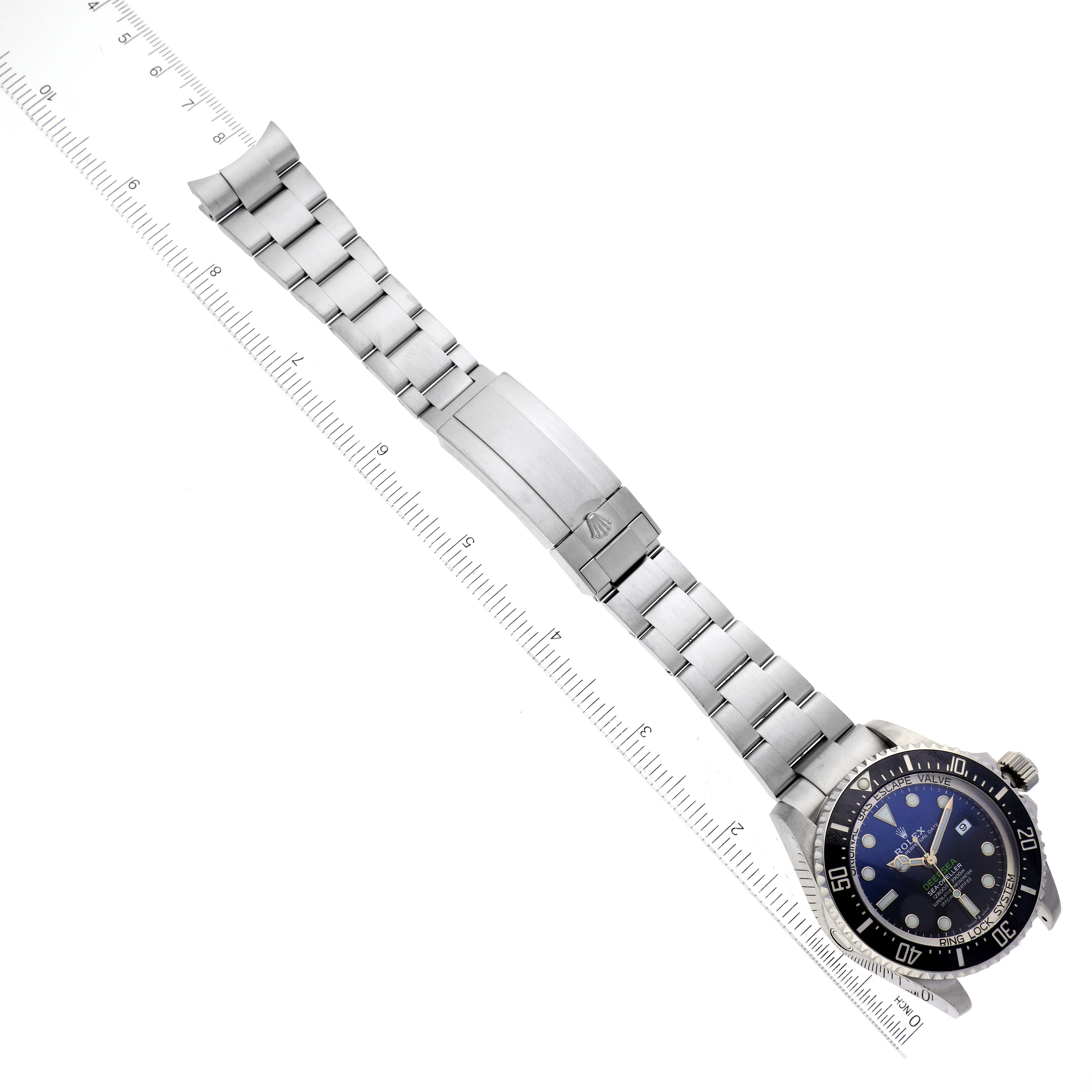 The image shows a top view of a Rolex Sea-Dweller 126660 Men's Stainless Steel Blue Dial 126660 Men's Stainless Steel Blue Dial watch, highlighting its face, bezel, and stainless steel bracelet against a ruler.