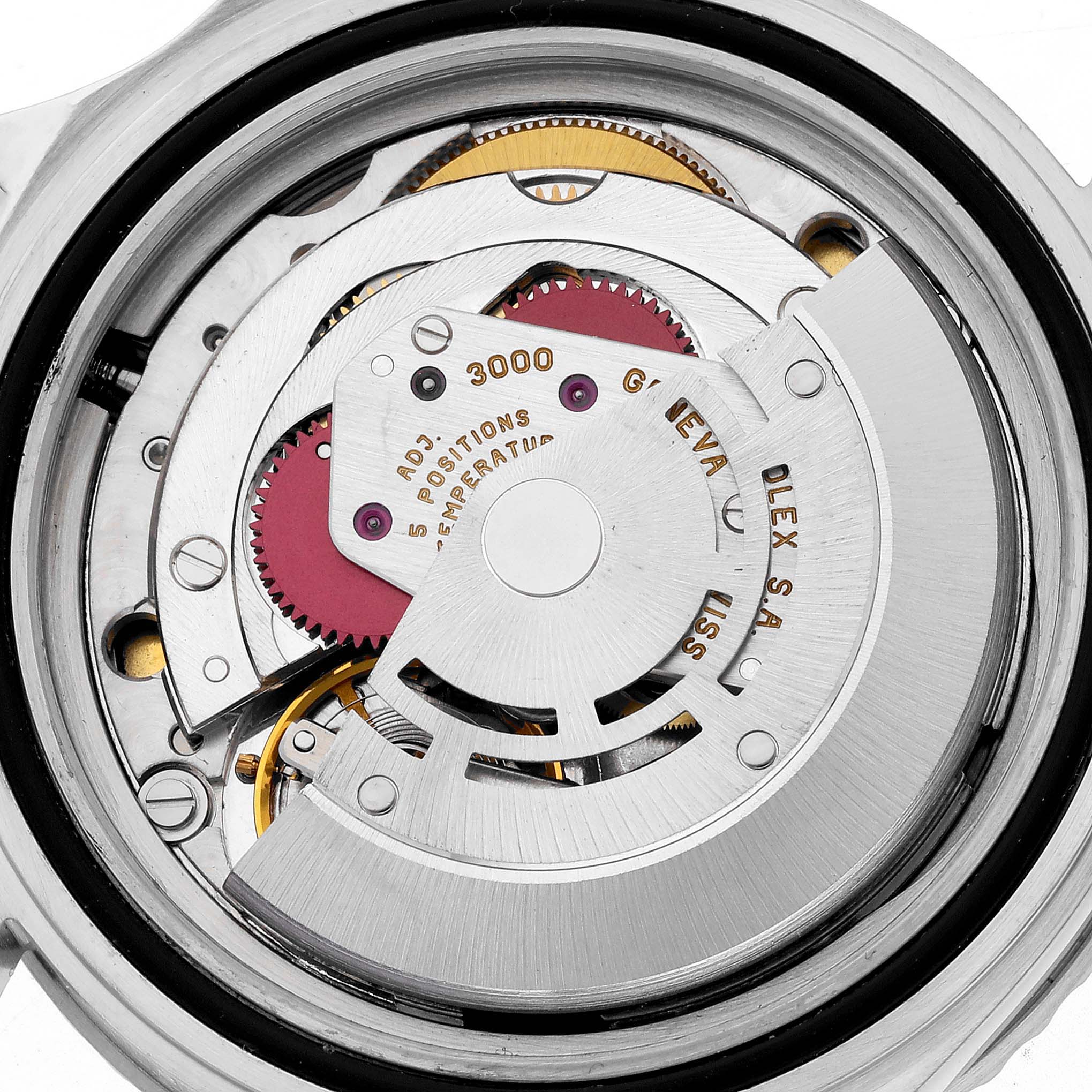 The image shows the intricate movement mechanism of a Rolex Submariner 14060 Men
s Stainless Steel Black Dial 14060 Men
s Stainless Steel Black Dial watch from a rear angle, highlighting gears and engravings.