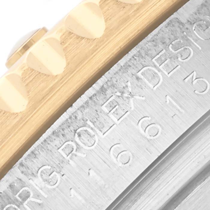 The image shows the side view of a Rolex Submariner 116613LB Men's Steel and Gold (two tone) Blue Dial 116613LB Men's Steel and Gold (two tone) Blue Dial, highlighting the bezel teeth and engraved serial number.