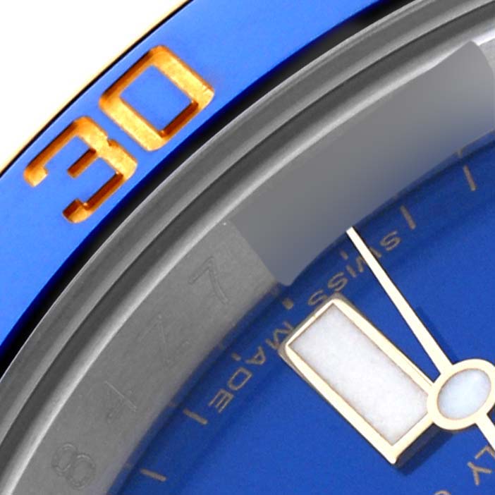 The image shows a close-up of the bezel and dial of a Rolex Submariner 116613LB Men's Steel and Gold (two tone) Blue Dial 116613LB Men's Steel and Gold (two tone) Blue Dial, highlighting the blue color and part of the minute hand.