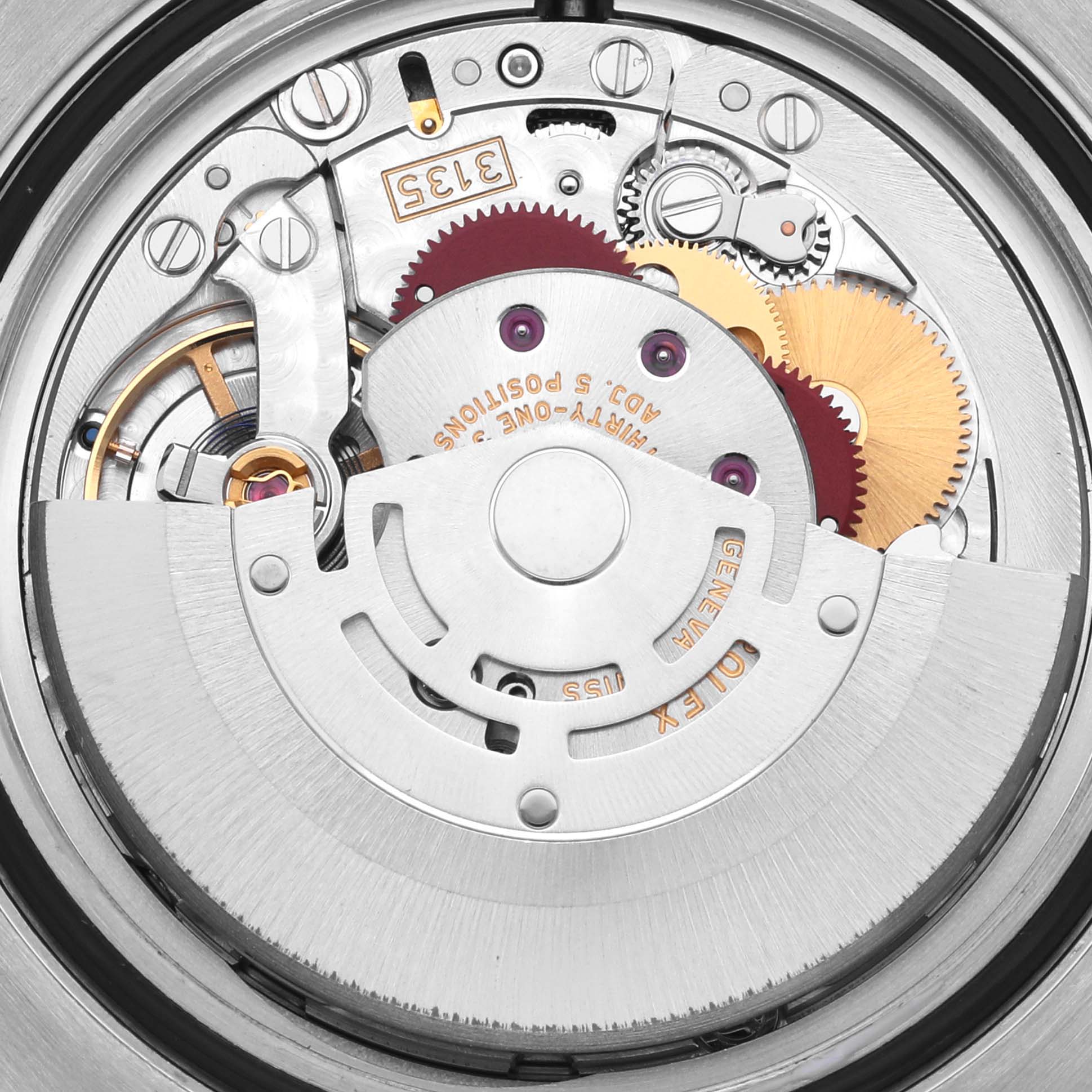 The image shows a close-up of the movement of a Rolex Submariner 116613LB Men's Steel and Gold (two tone) Blue Dial 116613LB Men's Steel and Gold (two tone) Blue Dial watch, displaying gears and the rotor from a top angle.