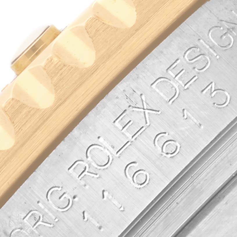 The image shows a close-up of a Rolex Submariner 116613LB Men's Steel and Gold (two tone) Blue Dial 116613LB Men's Steel and Gold (two tone) Blue Dial watch's engraved inner bezel and part of the gold edge of the case.