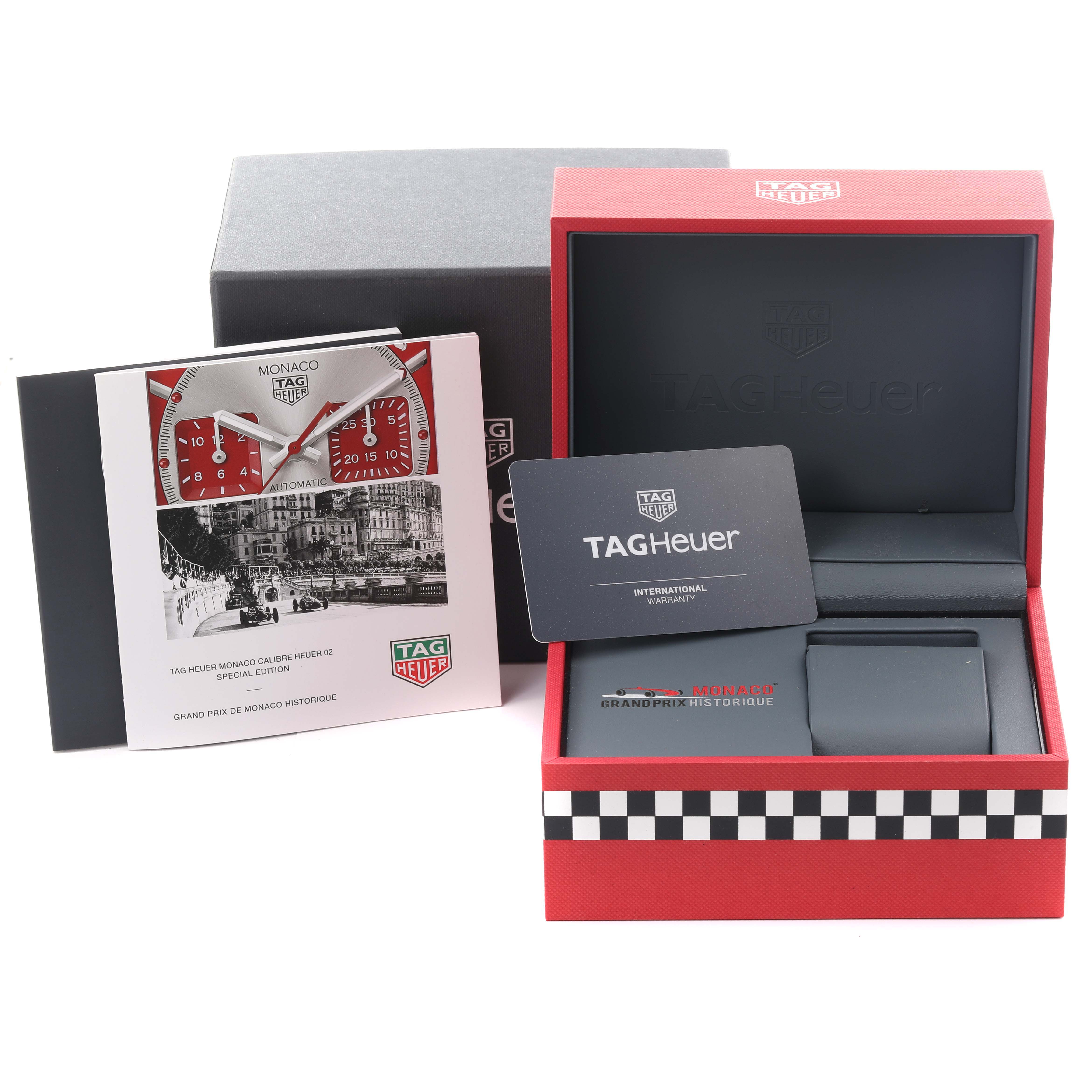 The Tag Heuer Monaco CBL2114 Men's Stainless Steel Red Dial CBL2114 Men's Stainless Steel Red Dial watch accessories include an open box, international warranty card, and brochure with watch images.