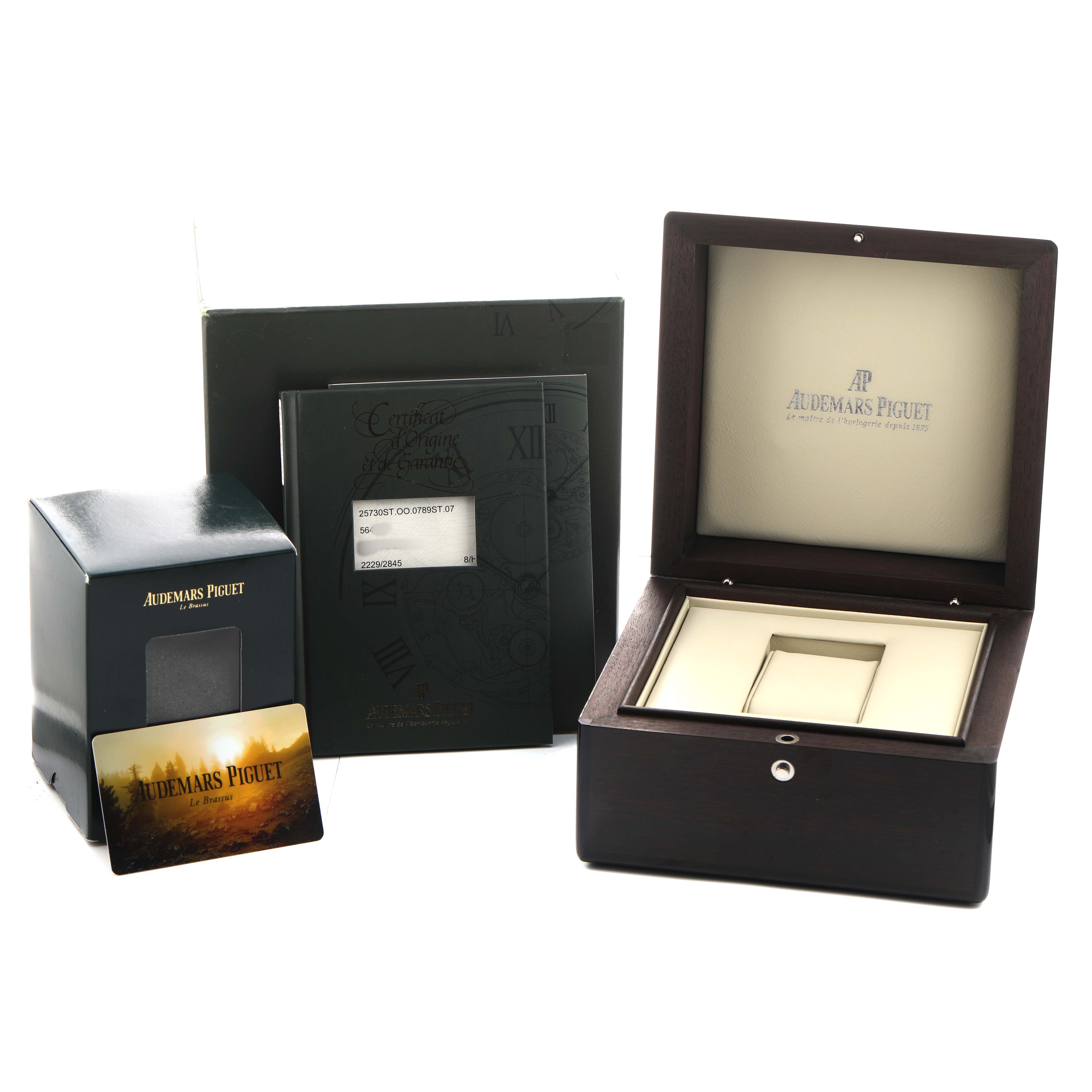 The image shows the box, booklet, and authenticity card for the Audemars Piguet Royal Oak 25730ST Men's Stainless Steel Blue Dial watch.