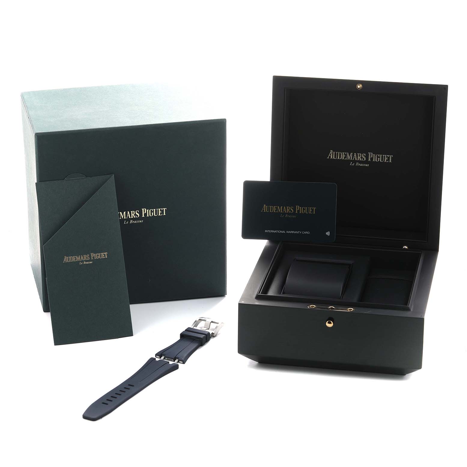 The image shows the packaging and accessories of the Audemars Piguet Royal Oak Offshore 26238ST Men's Stainless Steel Blue Dial, including the box, strap, and warranty card.