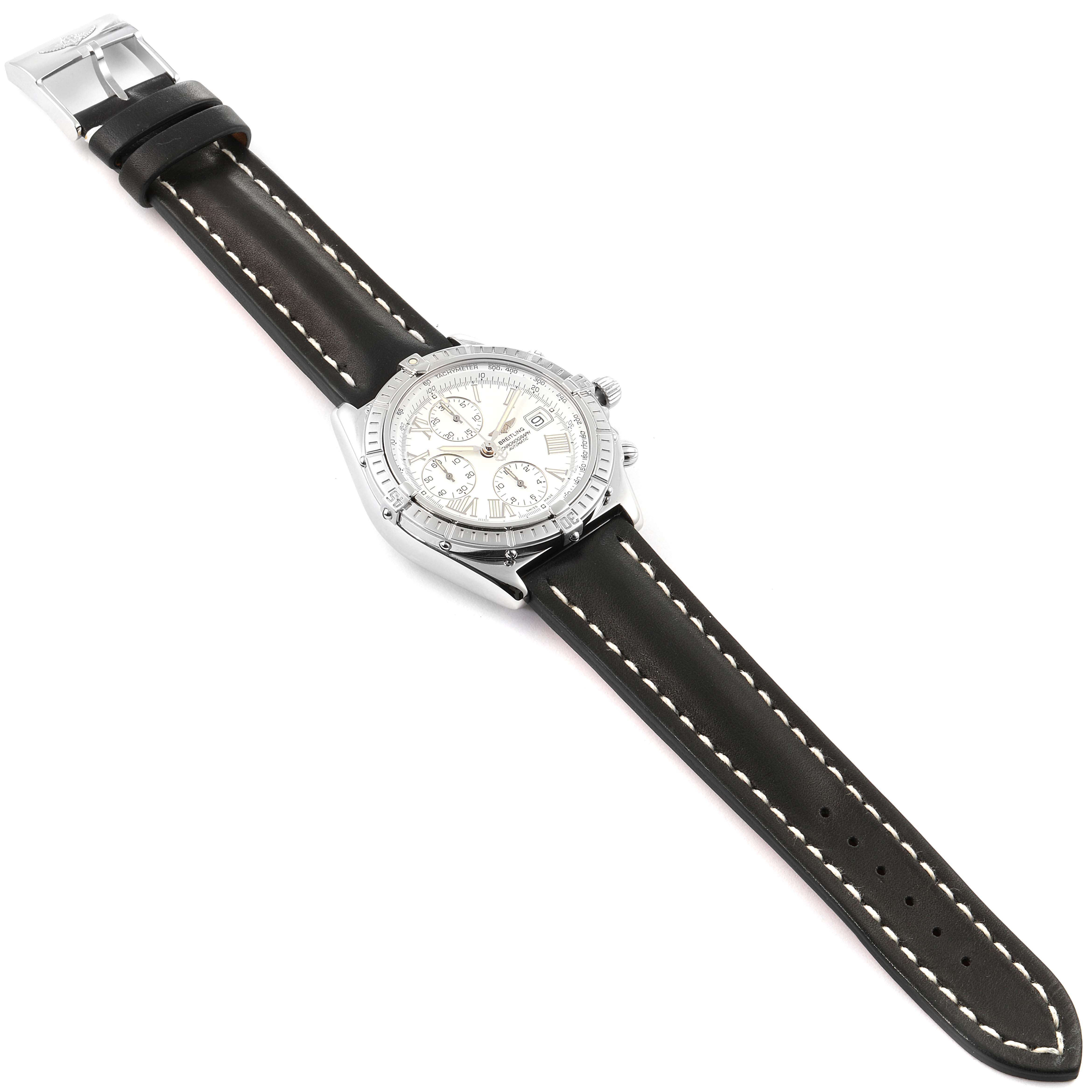 The Breitling Chronomat A13055 Men
s Stainless Steel Silver Dial A13055 Men
s Stainless Steel Silver Dial watch is shown from a top-down angle, displaying its dial, bezel, case, and leather strap.