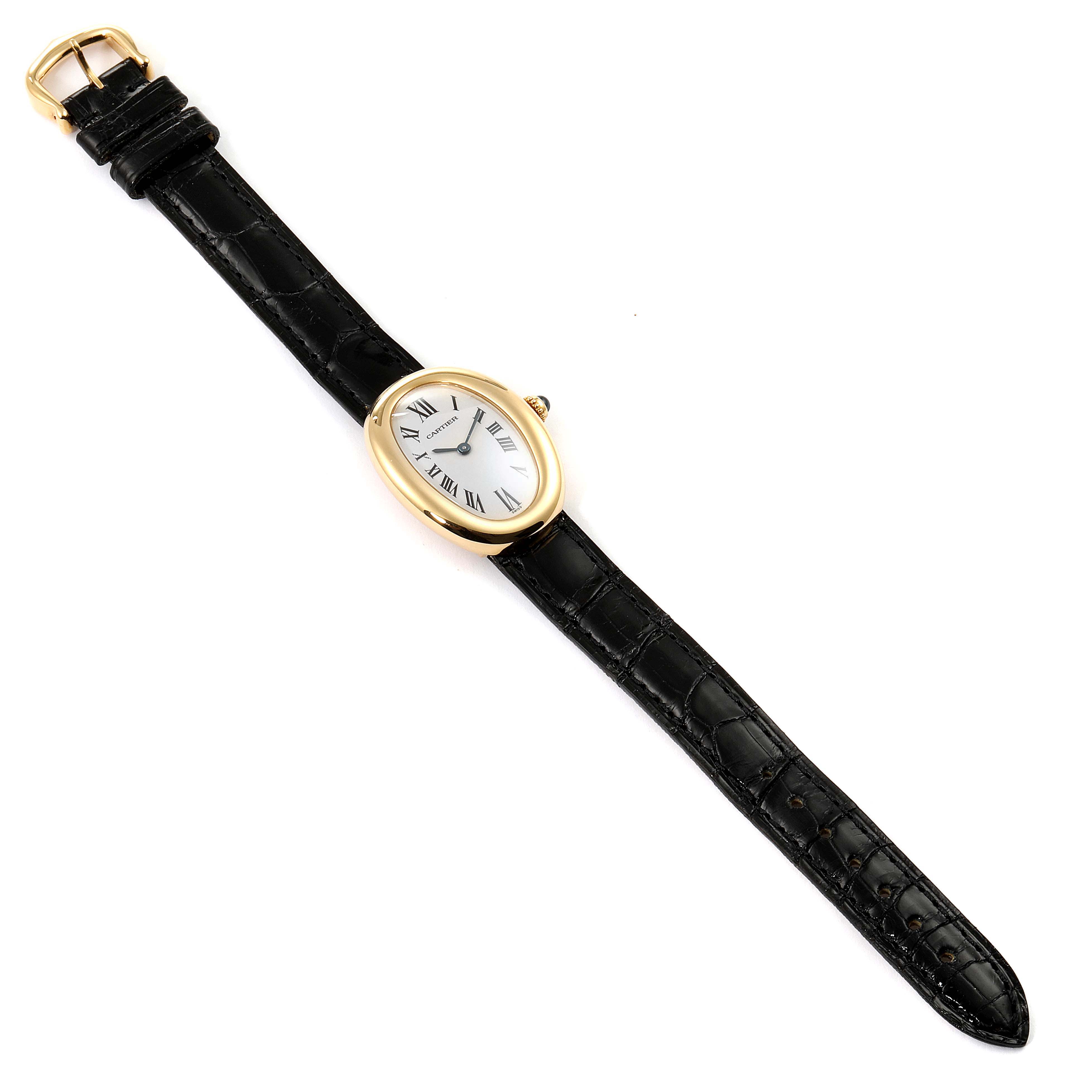 The image shows a top view of a Cartier Baignoire 1954 Women's Yellow Gold Silver Dial 1954 Women's Yellow Gold Silver Dial watch with a black leather strap and a gold oval case.