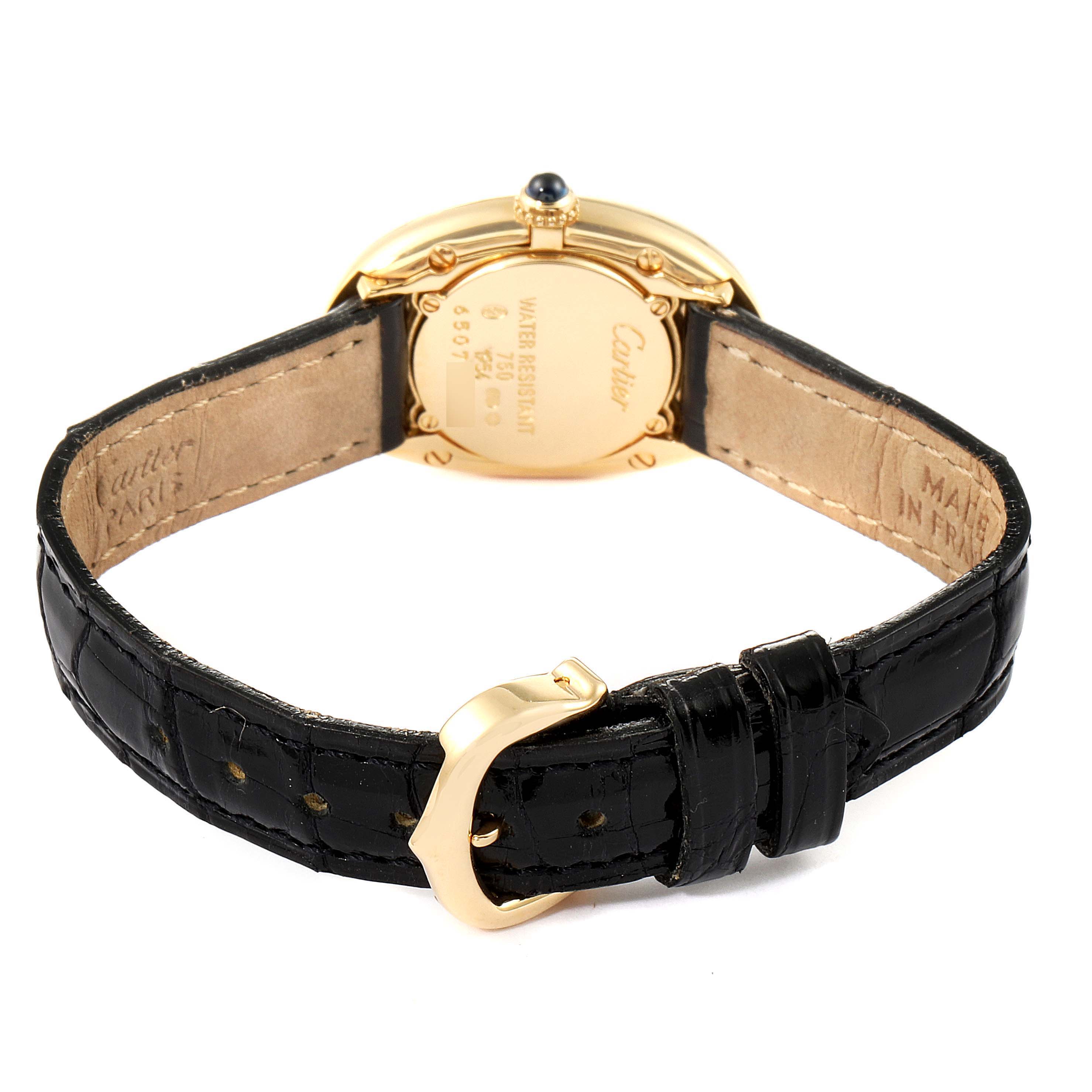 The image shows the back view of the Cartier Baignoire 1954 Women's Yellow Gold Silver Dial 1954 Women's Yellow Gold Silver Dial watch, featuring its case back, black leather strap, and clasp.