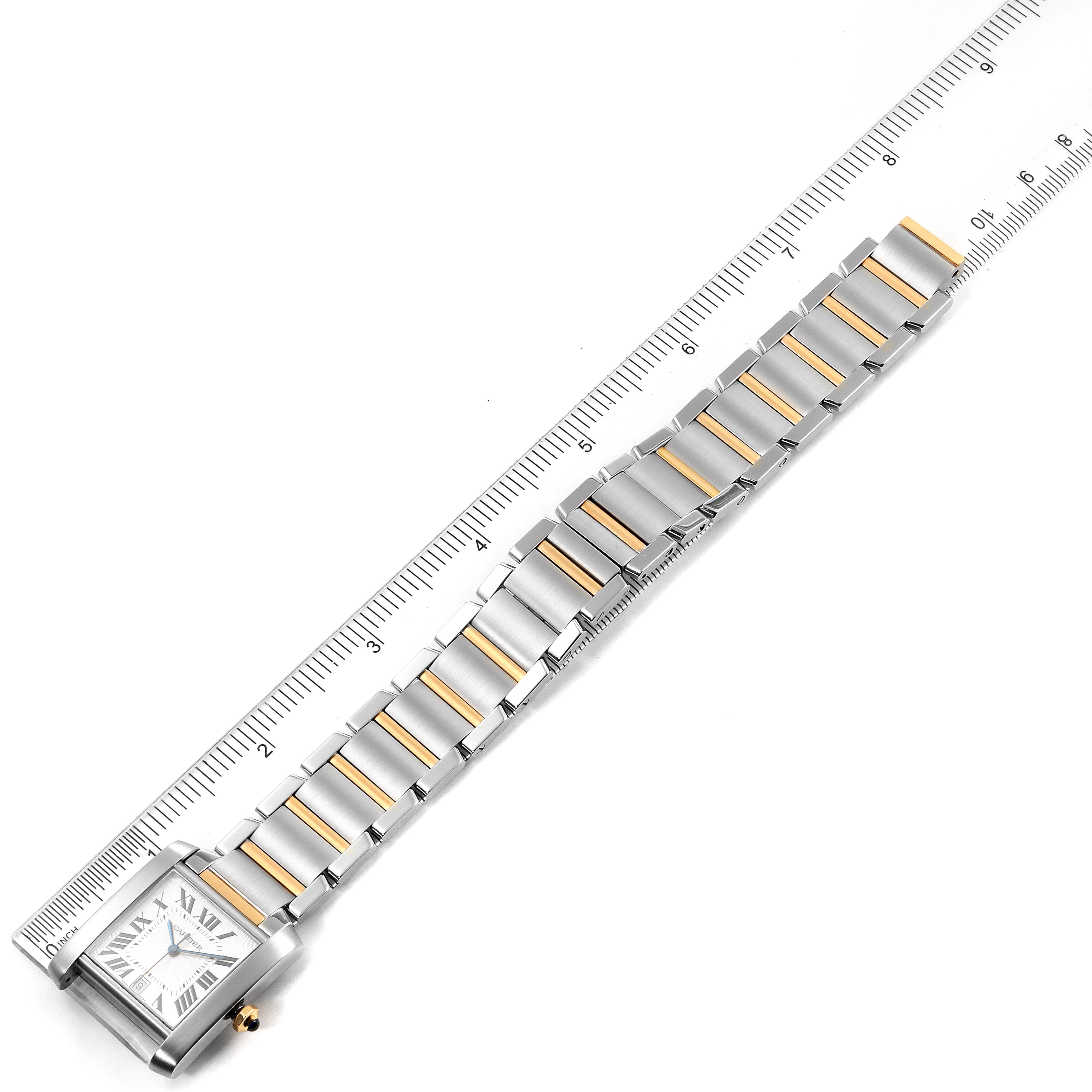 The Cartier Tank Francaise W51005Q4 Men's Stainless Steel Silver Dial W51005Q4 Men's Stainless Steel Silver Dial watch is shown from an overhead angle, featuring its face and bracelet alongside a ruler for scale.