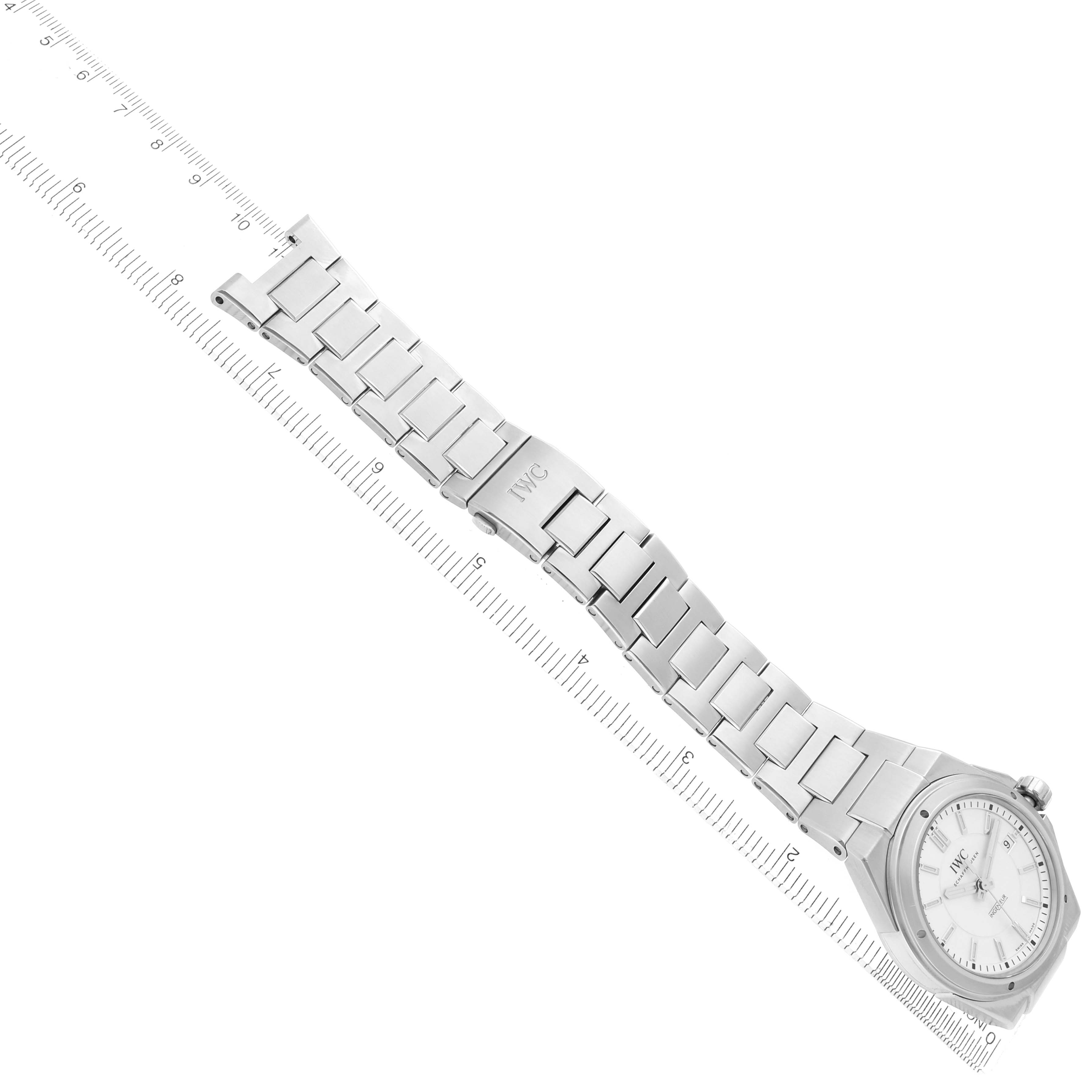 The IWC Ingenieur IW323904 Men's Stainless Steel White Dial watch is shown from a top view, displaying the full bracelet and clasp alongside a ruler for scale.