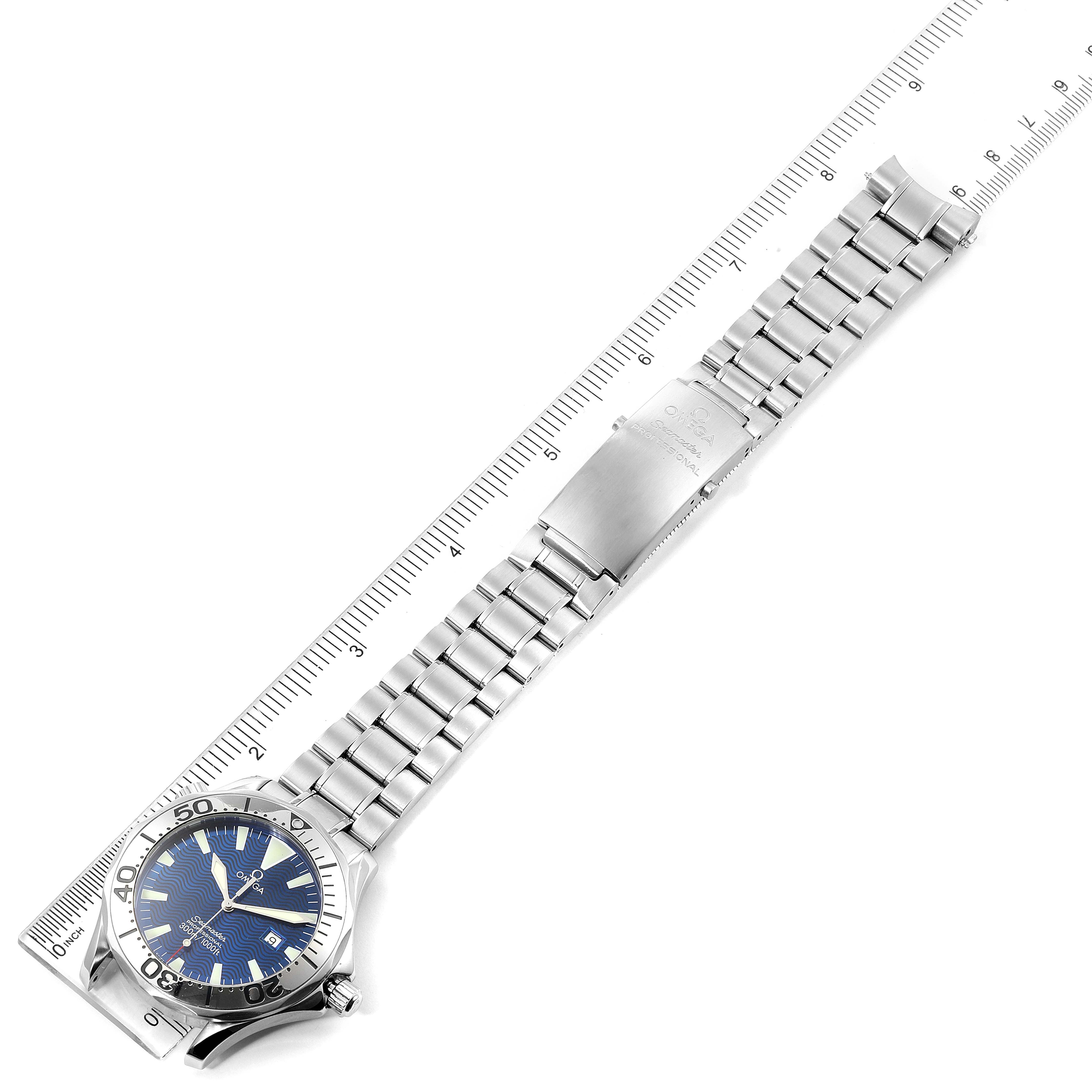 The Omega Seamaster 2265.80.00 Men
s Stainless Steel Blue Dial 2265.80.00 Men
s Stainless Steel Blue Dial watch is shown flat with a metal bracelet fully extended next to a ruler for scale.