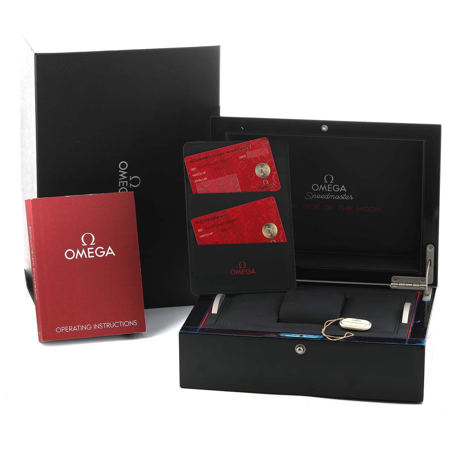 The Omega Speedmaster 311.92.44.51.01.007 Men's Ceramic Black Dial model is shown with its box, two red cards, and a manual, viewed from the front.