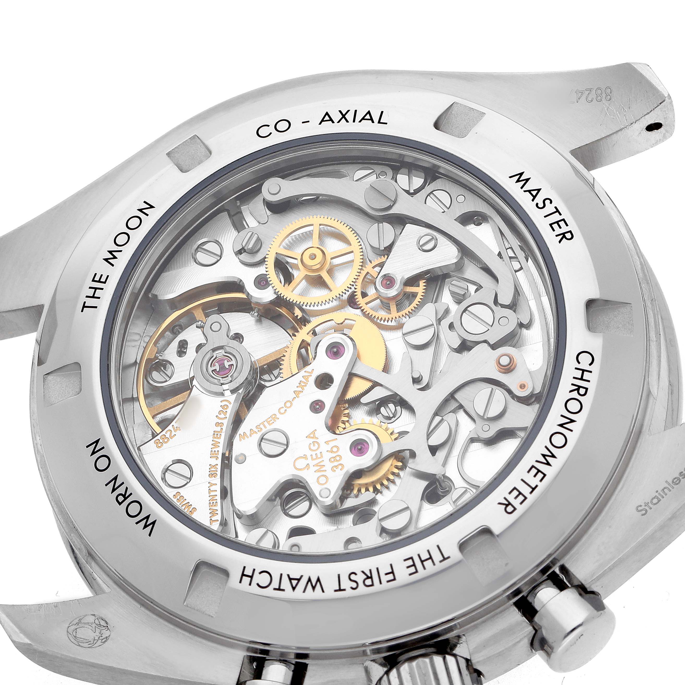 The image shows the back of an Omega Speedmaster 310.32.42.50.04.002 Men's Stainless Steel White Dial watch, highlighting its intricate mechanical movement and case engravings.