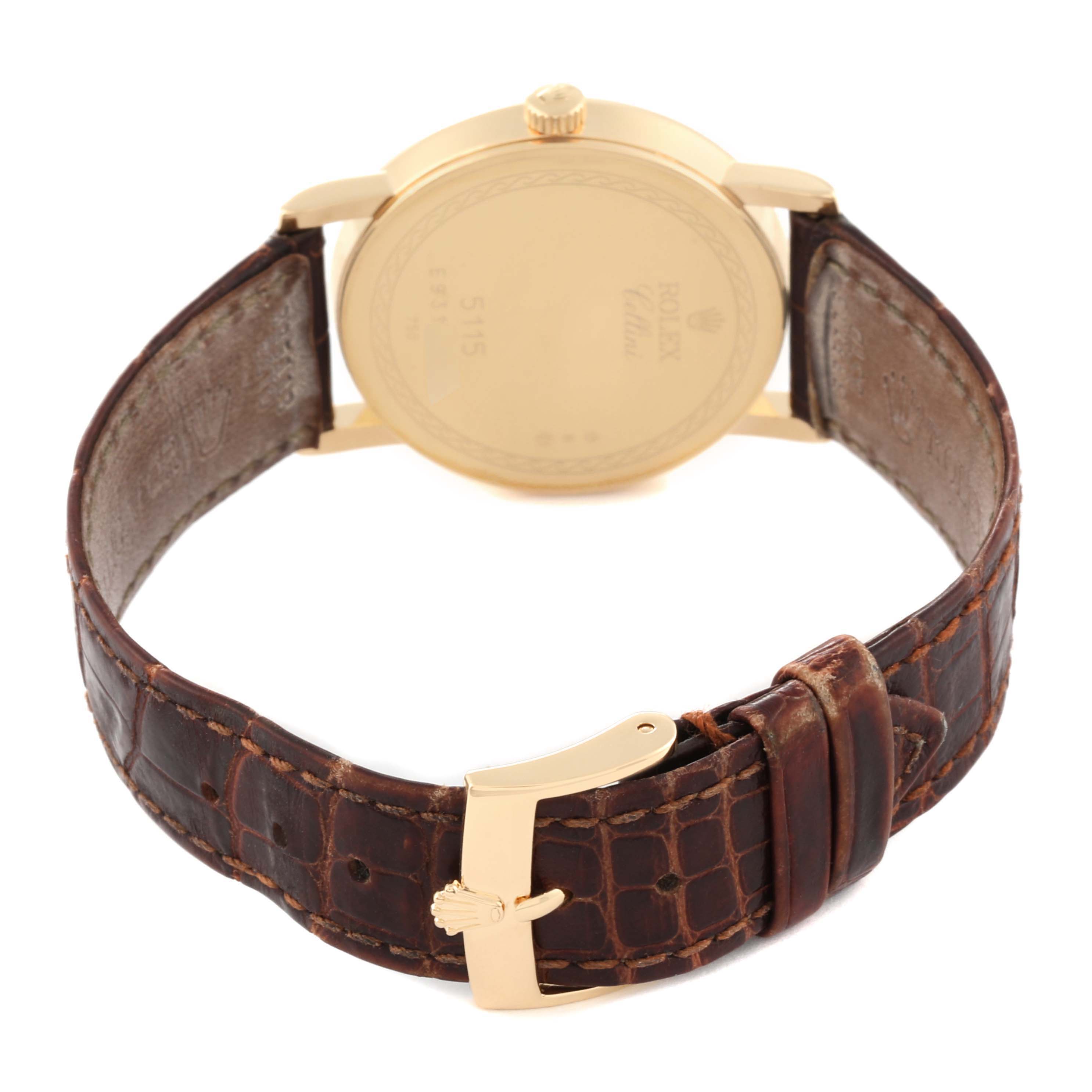 This image shows the back of a Rolex Cellini 5115/8 Men's Yellow Gold Silver Dial 5115/8 Men's Yellow Gold Silver Dial watch with a focus on its brown leather strap and gold clasp.