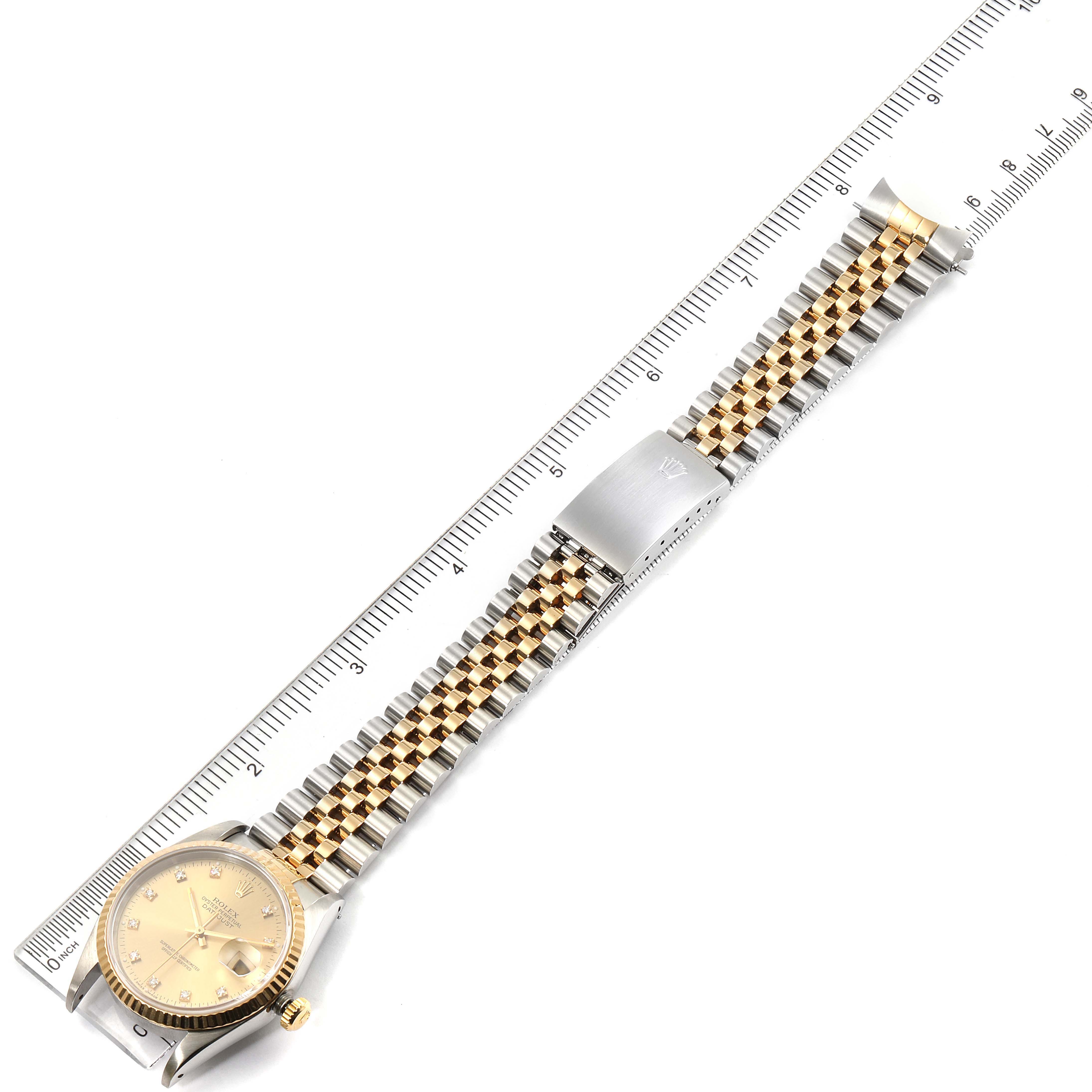 This image shows the Rolex Datejust 16233 Men's Steel and Gold (two tone) Champagne Dial 16233 Men's Steel and Gold (two tone) Champagne Dial watch, including the face, clasp, and full bracelet, displayed alongside a ruler for size reference.