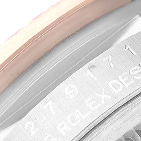 This close-up shows the edge of the bezel and part of the engraved inner ring of a Rolex Datejust 279171 Women's Steel and Gold (two tone) Brown Dial 279171 Women's Steel and Gold (two tone) Brown Dial watch.