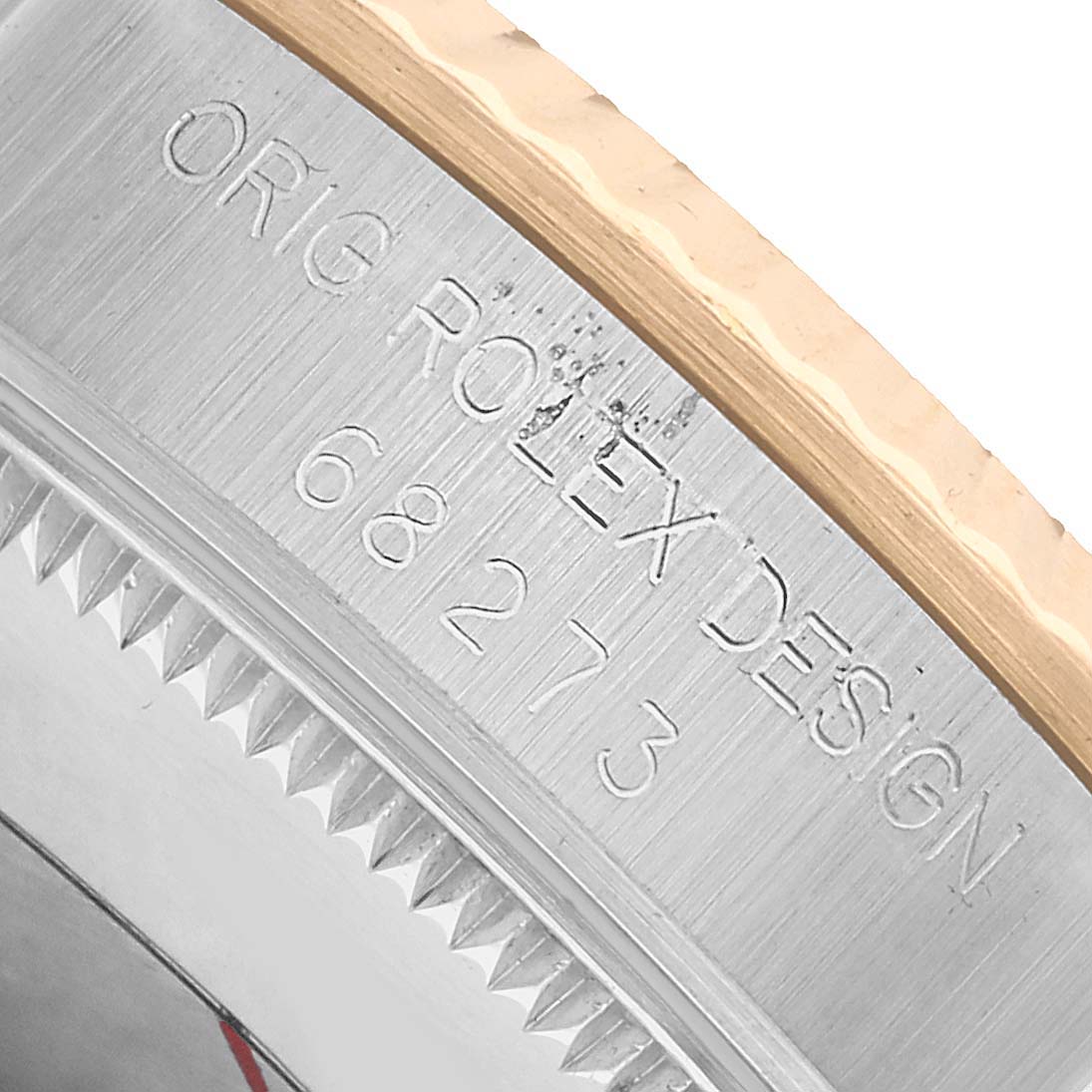 The image shows a close-up of the side of a Rolex Mid-Size 68273 Women's Steel and Gold (two tone) White Dial model, highlighting the bezel and engraving.