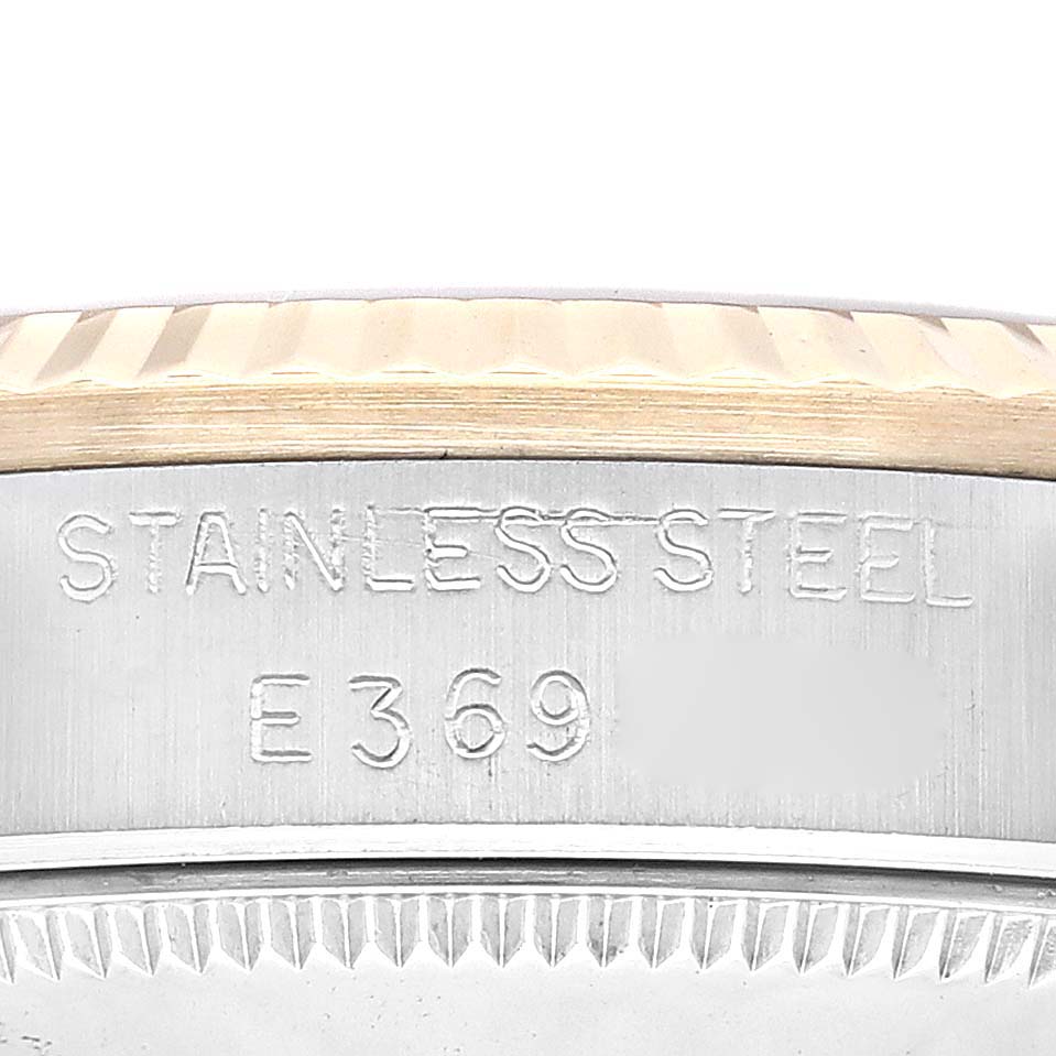 This image shows a close-up of the side view and bezel of the Mid-Size Rolex watch, highlighting its "STAINLESS STEEL E369" engraving.