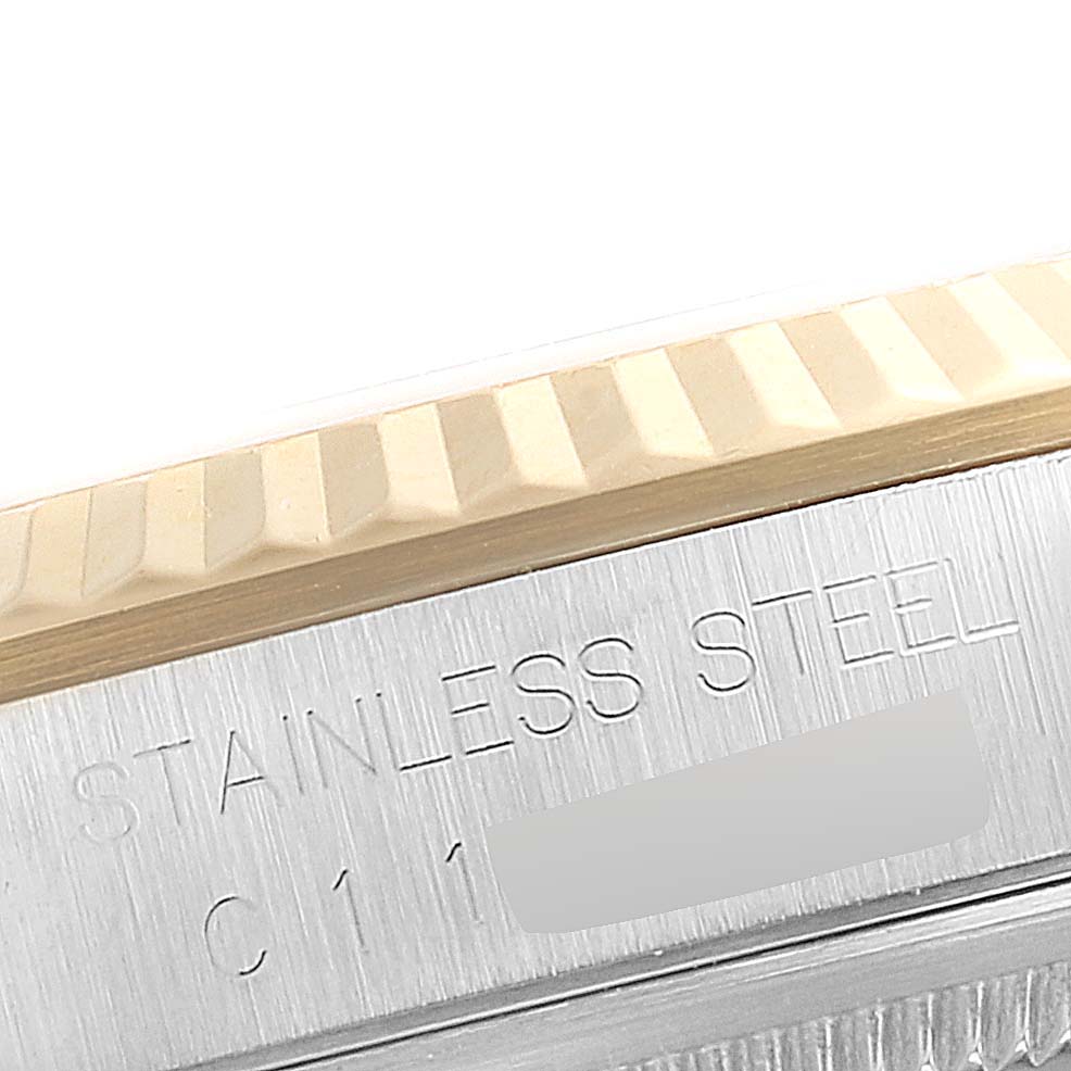 This close-up shows the fluted bezel and stainless steel case with an engraving of the Rolex Datejust 16233 Men's Steel and Gold (two tone) Champagne Dial 16233 Men's Steel and Gold (two tone) Champagne Dial model.