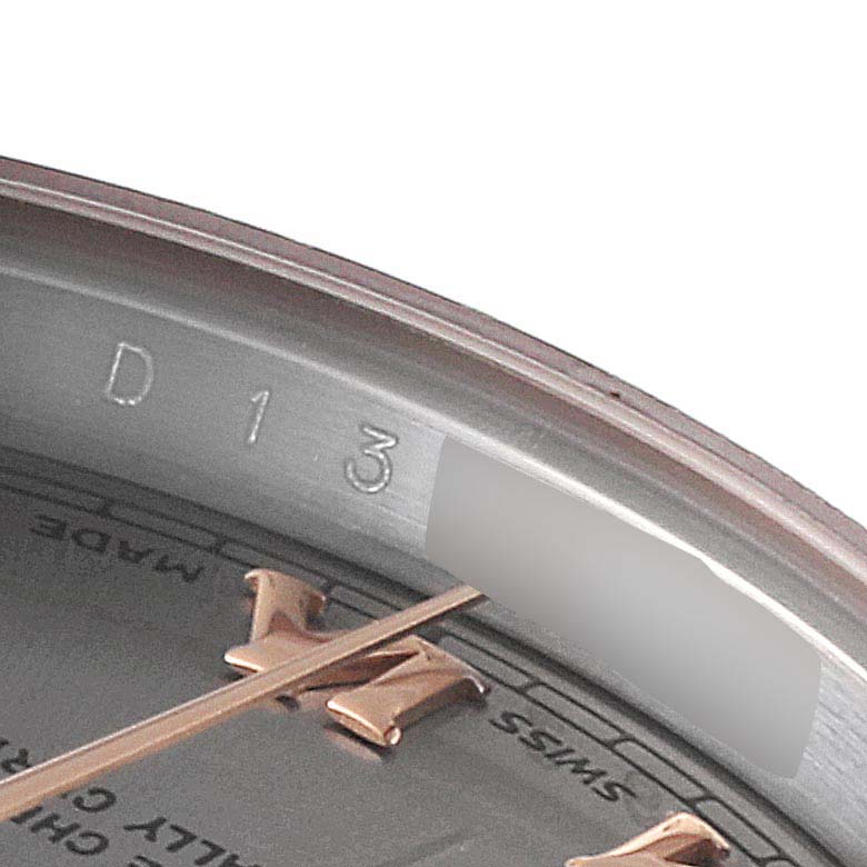 This image shows a close-up of the rehaut and part of the dial of a Rolex Datejust 179171 Women's Steel and Gold (two tone) Grey Dial 179171 Women's Steel and Gold (two tone) Grey Dial watch, including the engraved serial number.