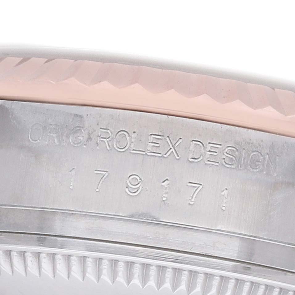 The image shows a close-up of the edge and serial engraving on the side of a Rolex Datejust 179171 Women's Steel and Gold (two tone) Mother of Pearl Dial watch case.