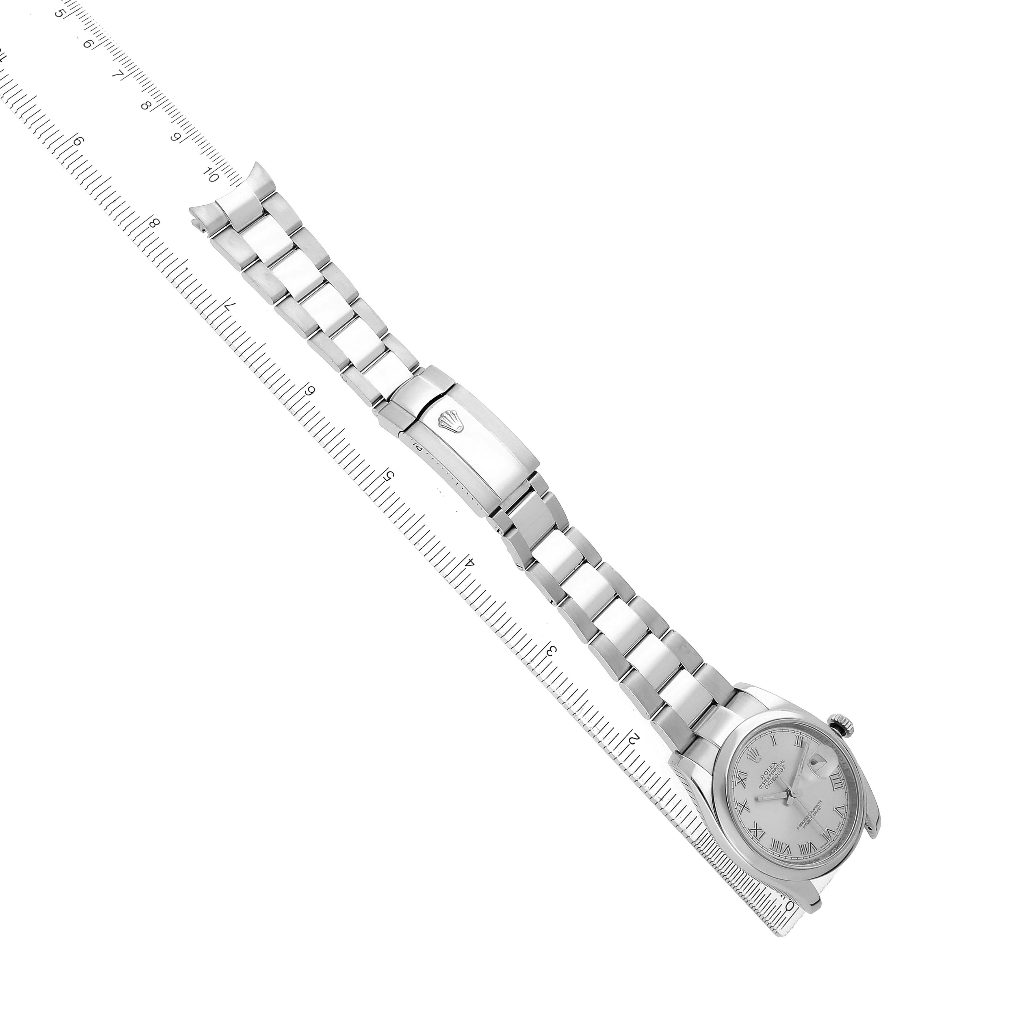 The image shows a Rolex Datejust 116200 Men's Stainless Steel Silver Dial watch sitting diagonally, displaying the bracelet, clasp, and face with a ruler for scale.