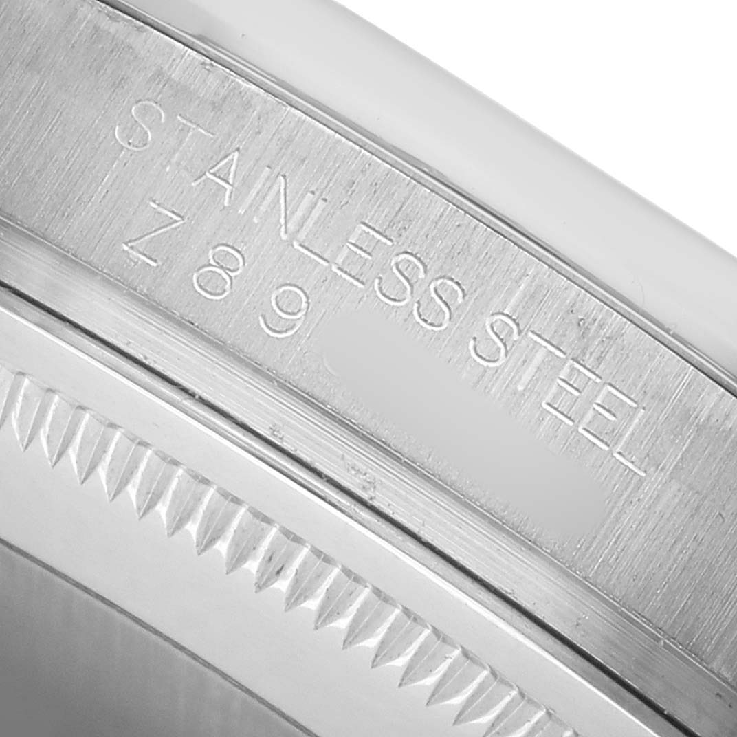 The image shows a close-up of the stainless steel case side and bezel of the Rolex Datejust 116200 Men's Stainless Steel Silver Dial watch.