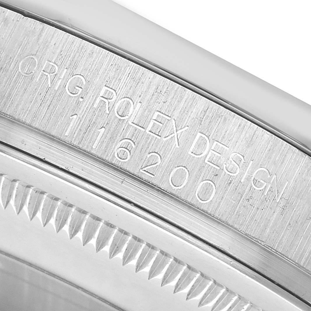 The image shows a close-up of the Rolex Datejust 116200 Men's Stainless Steel Silver Dial case side, highlighting the model engraving.