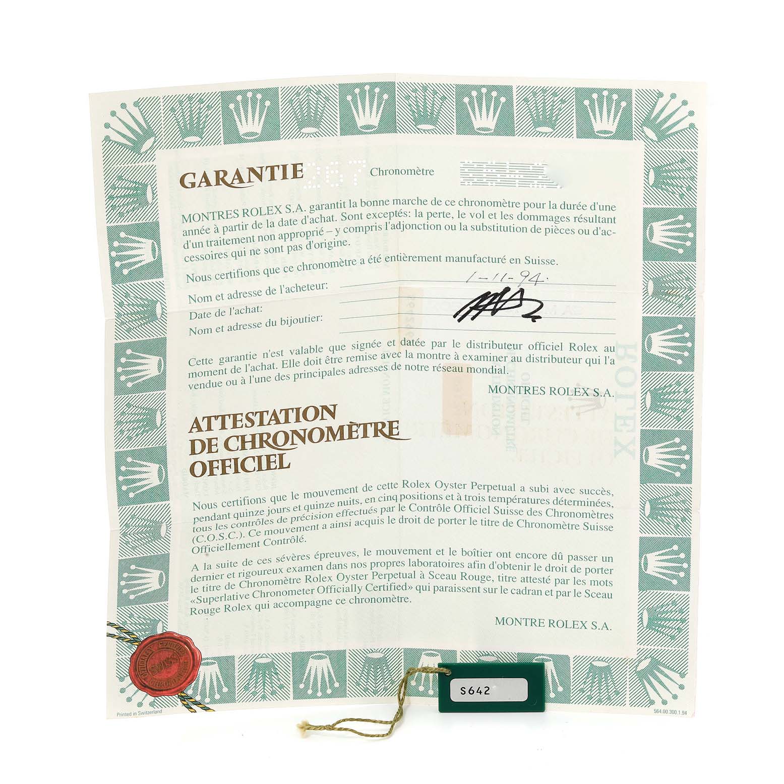 The image shows a warranty certificate and a green tag with the serial number for a Rolex Datejust 69174 Women's Stainless Steel Silver Dial 69174 Women's Stainless Steel Silver Dial watch.