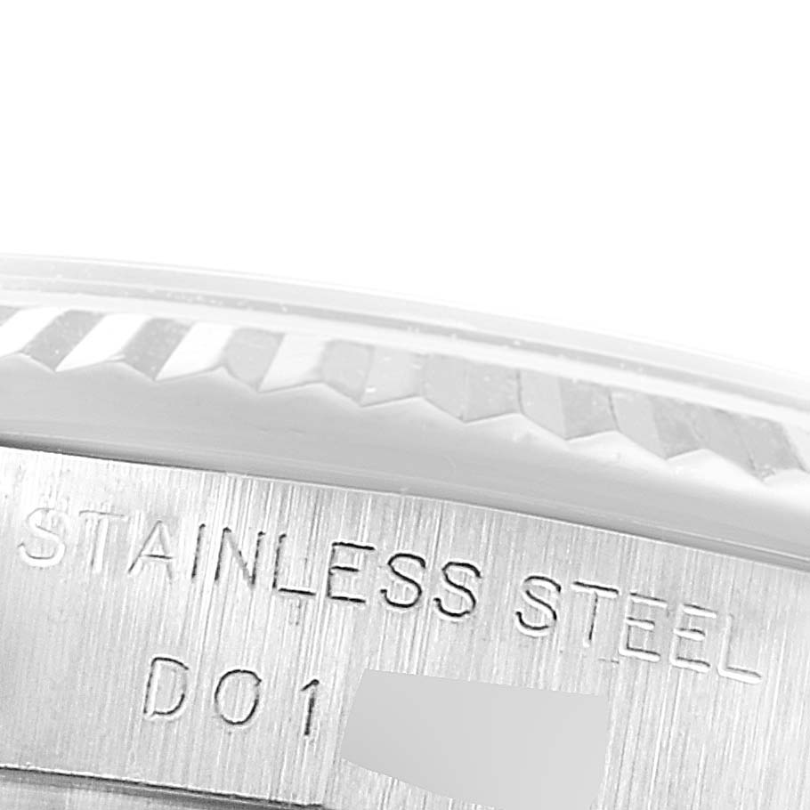 This close-up image shows the stainless steel casing and part of the fluted bezel of a Rolex Datejust 179174 Women's Stainless Steel Silver Dial 179174 Women's Stainless Steel Silver Dial watch.