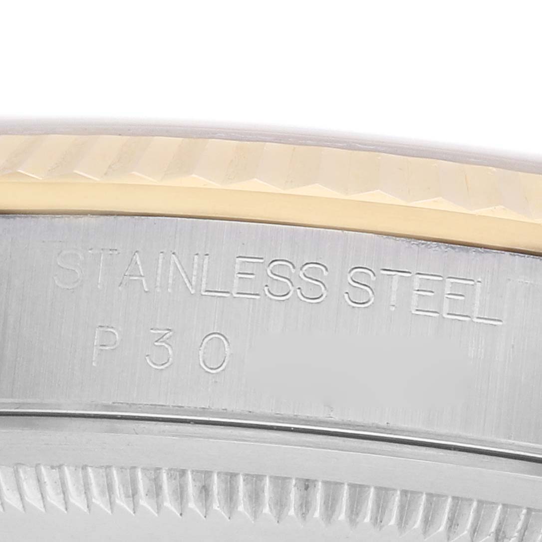 The image shows a close-up of the side of a Rolex Datejust 16233 Men's Steel and Gold (two tone) Champagne Dial watch, focusing on the "STAINLESS STEEL" engraving and case edges.
