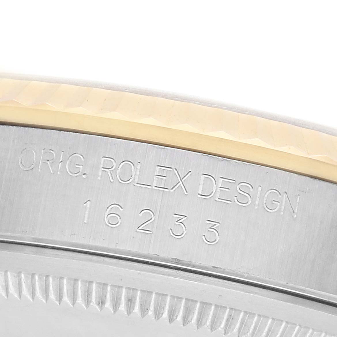 The image shows a close-up of the side of a Rolex Datejust 16233 Men's Steel and Gold (two tone) Champagne Dial, focusing on its engraved design number and part of the bezel.