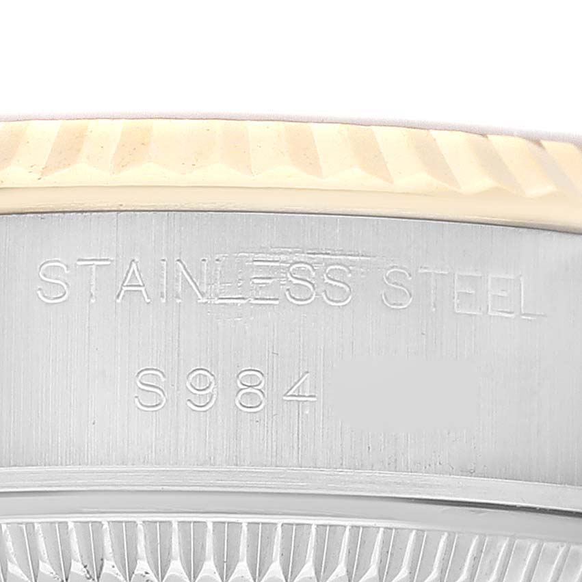 This close-up image shows the side of the Rolex Datejust 69173 Women's Steel and Gold (two tone) Champagne Dial 69173 Women's Steel and Gold (two tone) Champagne Dial watch, focusing on the engraved stainless steel description.