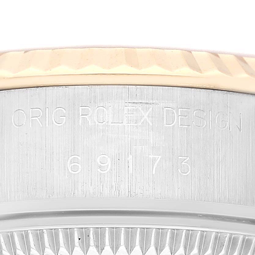 The image shows a close-up of the engraved side of a Datejust model by Rolex, featuring the bezel and reference number.