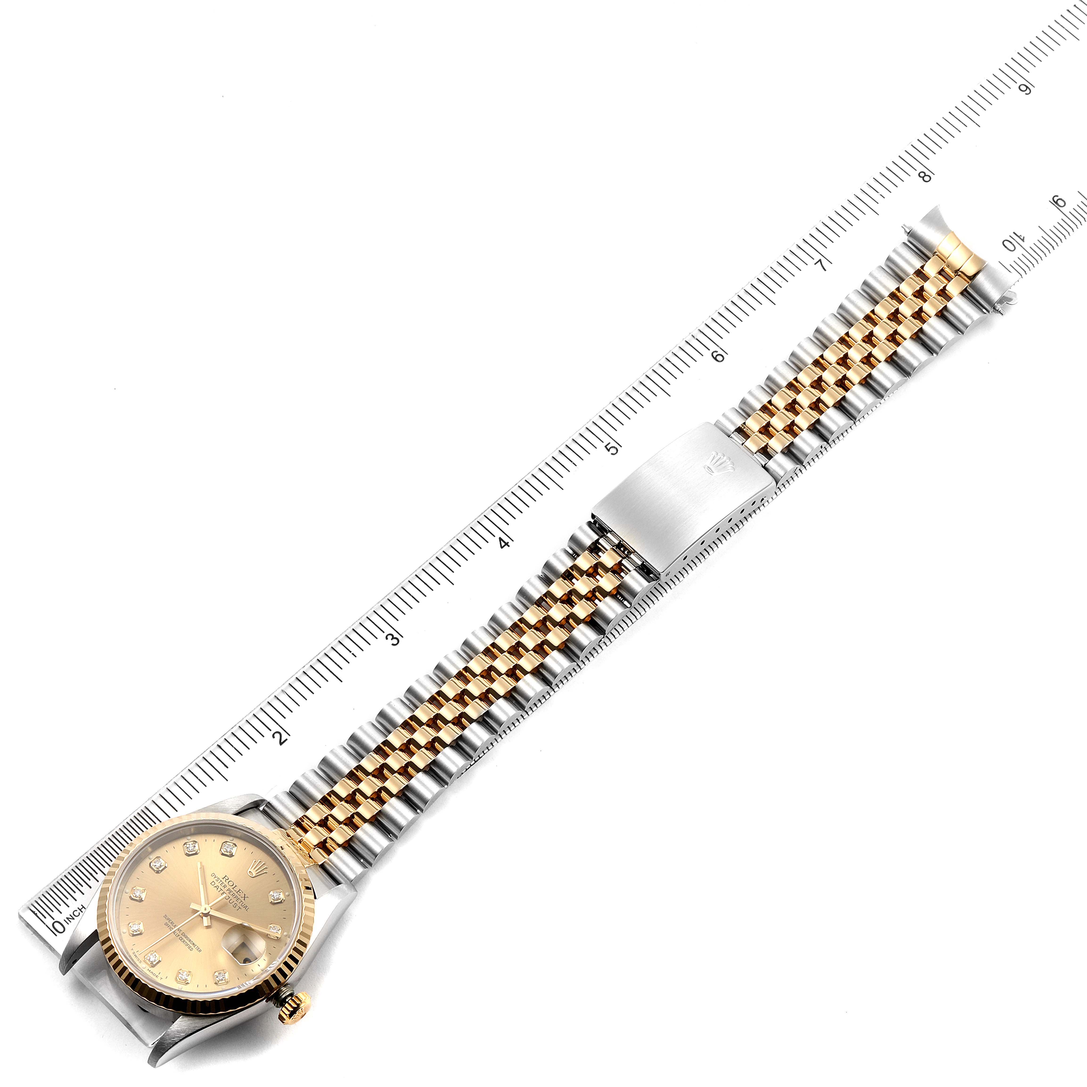 The image shows a Rolex Datejust 16233 Men's Steel and Gold (two tone) Champagne Dial 16233 Men's Steel and Gold (two tone) Champagne Dial watch laid flat alongside a ruler, highlighting its bracelet and clasp.