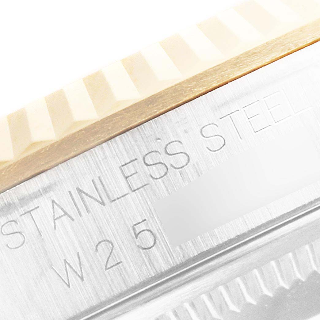 The image shows a close-up of the fluted bezel and the engraved edge of the case of a Rolex Datejust 16233 Men
s Steel and Gold (two tone) Champagne Dial 16233 Men
s Steel and Gold (two tone) Champagne Dial watch.