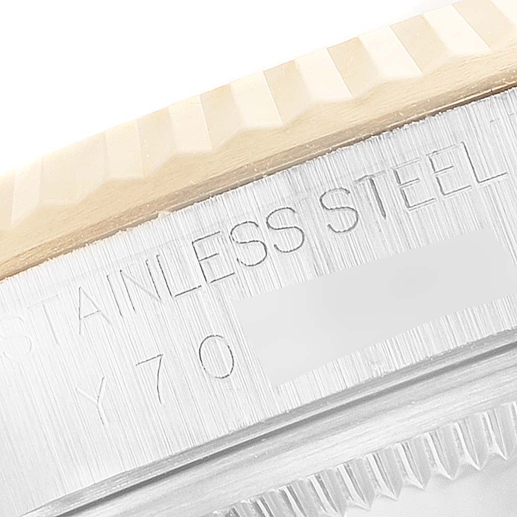 This image shows a close-up view of the fluted bezel and engraved "STAINLESS STEEL" text on a Rolex Datejust 16233 Men's Steel and Gold (two tone) Silver Dial 16233 Men's Steel and Gold (two tone) Silver Dial watch.