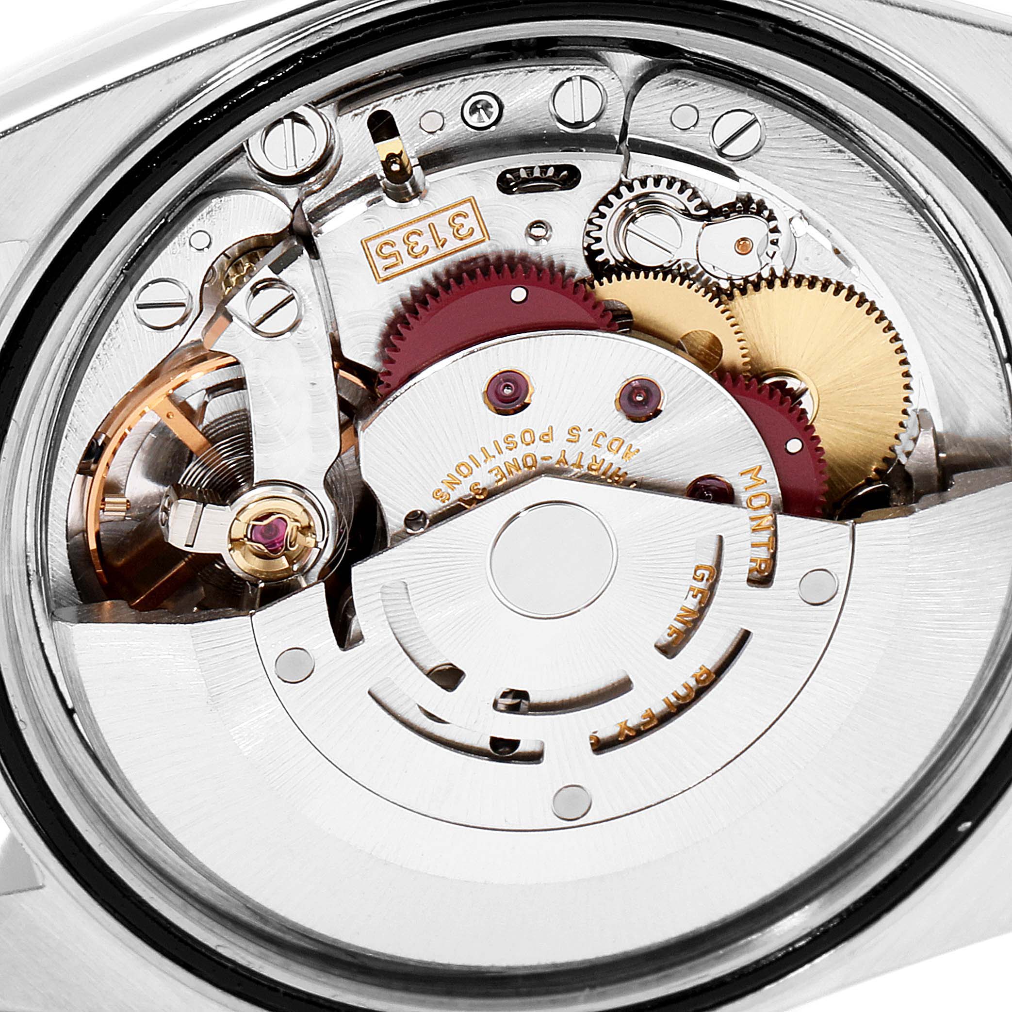The image shows the inner mechanical movement of a Rolex Datejust 16233 Men's Steel and Gold (two tone) Silver Dial 16233 Men's Steel and Gold (two tone) Silver Dial watch from a rear angle, highlighting its gears and rotor.