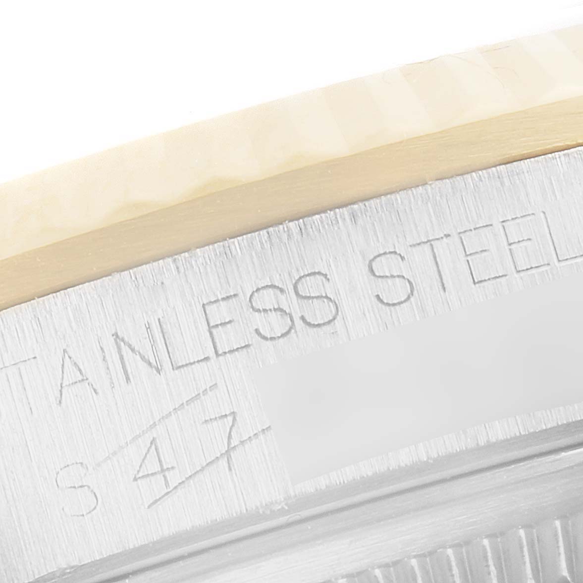 Close-up of the caseback edge of the Rolex Datejust 16233 Men's Steel and Gold (two tone) Champagne Dial 16233 Men's Steel and Gold (two tone) Champagne Dial, showing part of the engraved "STAINLESS STEEL" text.