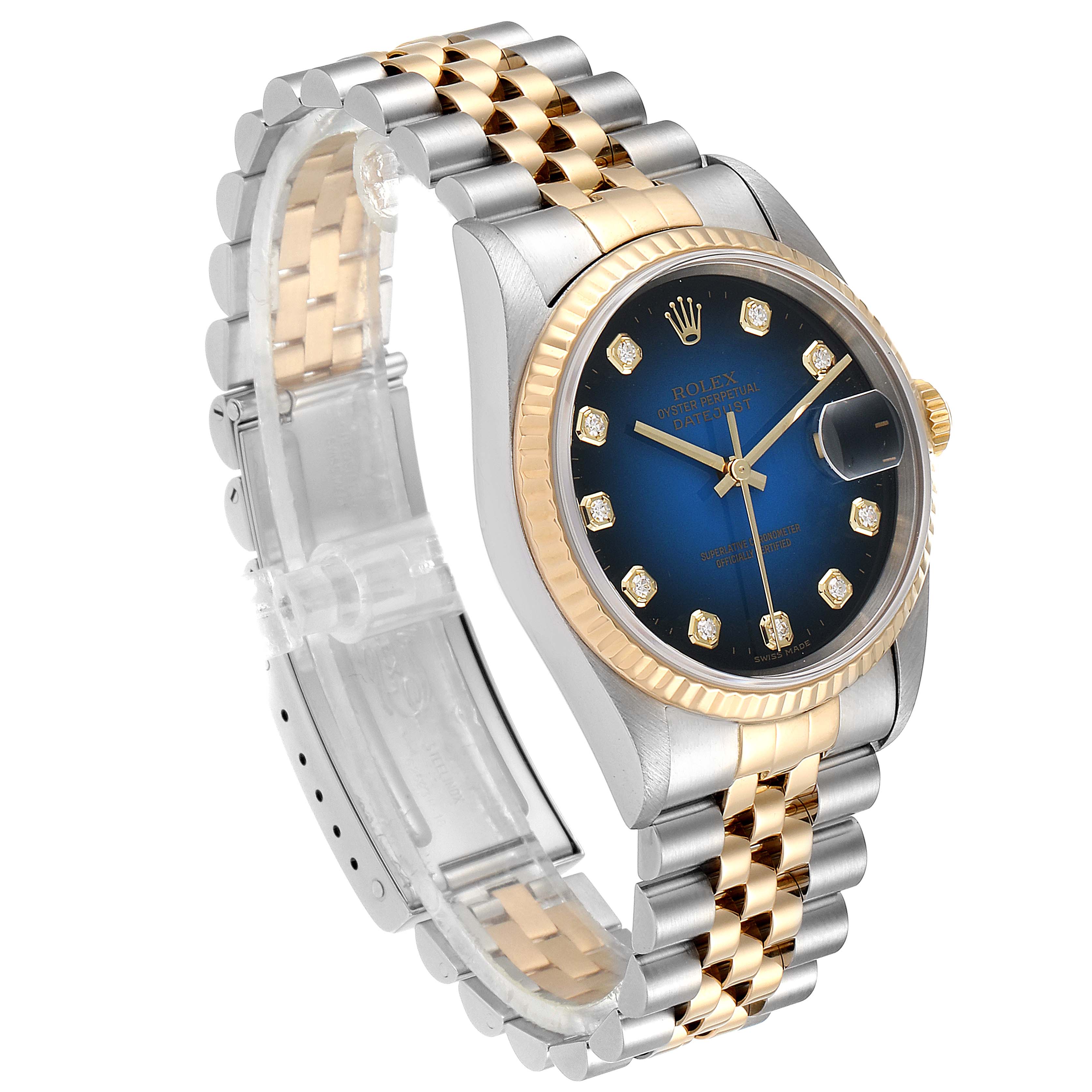 This image shows the Rolex Datejust 16233 Men's Steel and Gold (two tone) Blue Dial 16233 Men's Steel and Gold (two tone) Blue Dial model watch from a three-quarter angle, highlighting its two-tone bracelet, blue dial, and fluted bezel.