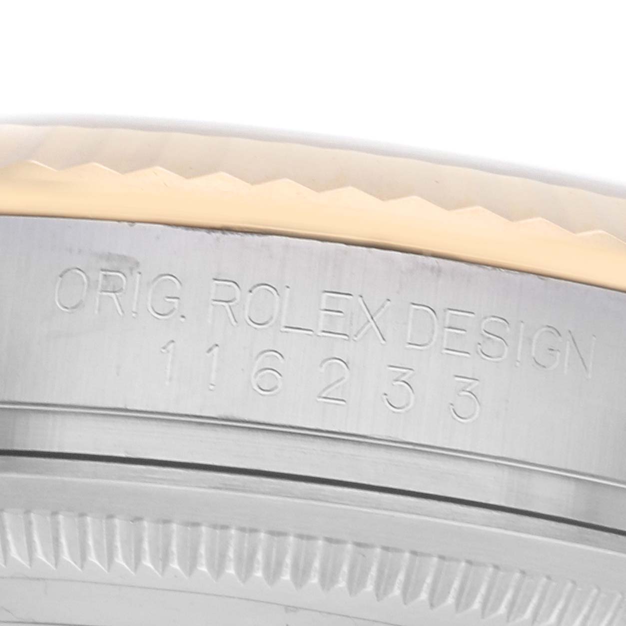 The image shows a close-up of the side of a Rolex Datejust 116233 Men's Steel and Gold (two tone) White Dial watch casing with visible engraved text.